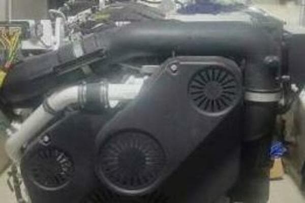 Engine of a 2022 Custom Freestyle Marine 32 boat, showcasing intricate mechanical components.