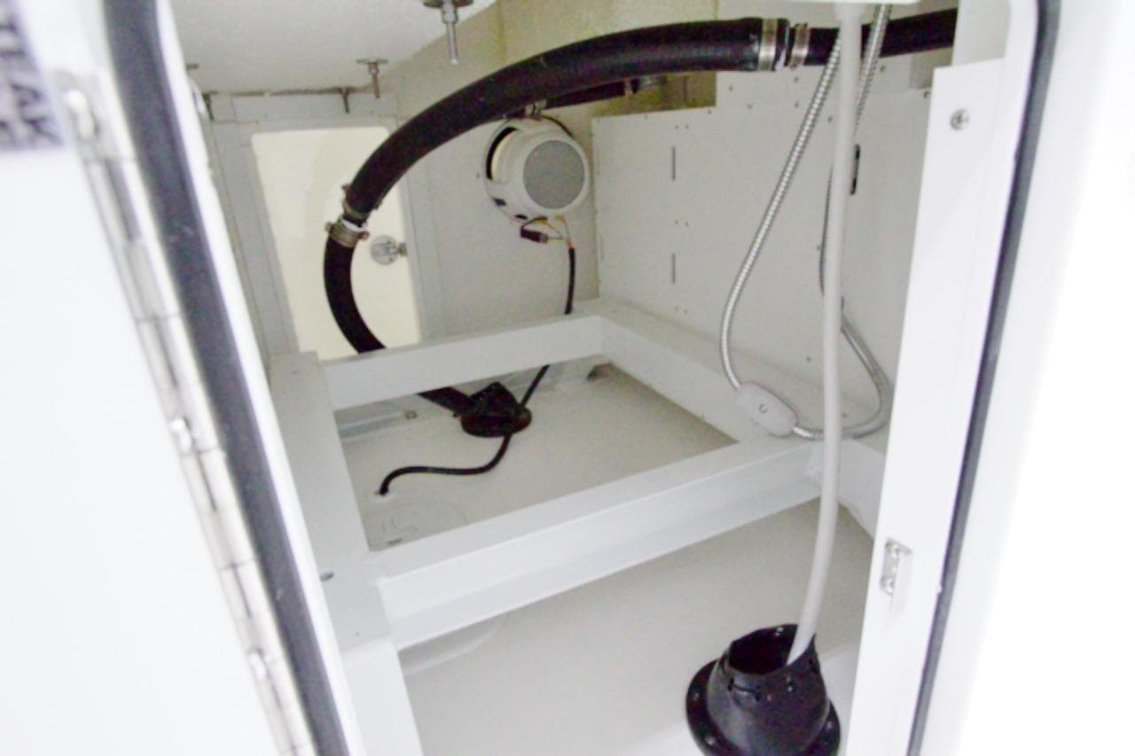Interior view of 2026 Regulator 31 boat compartment with hoses and wiring.