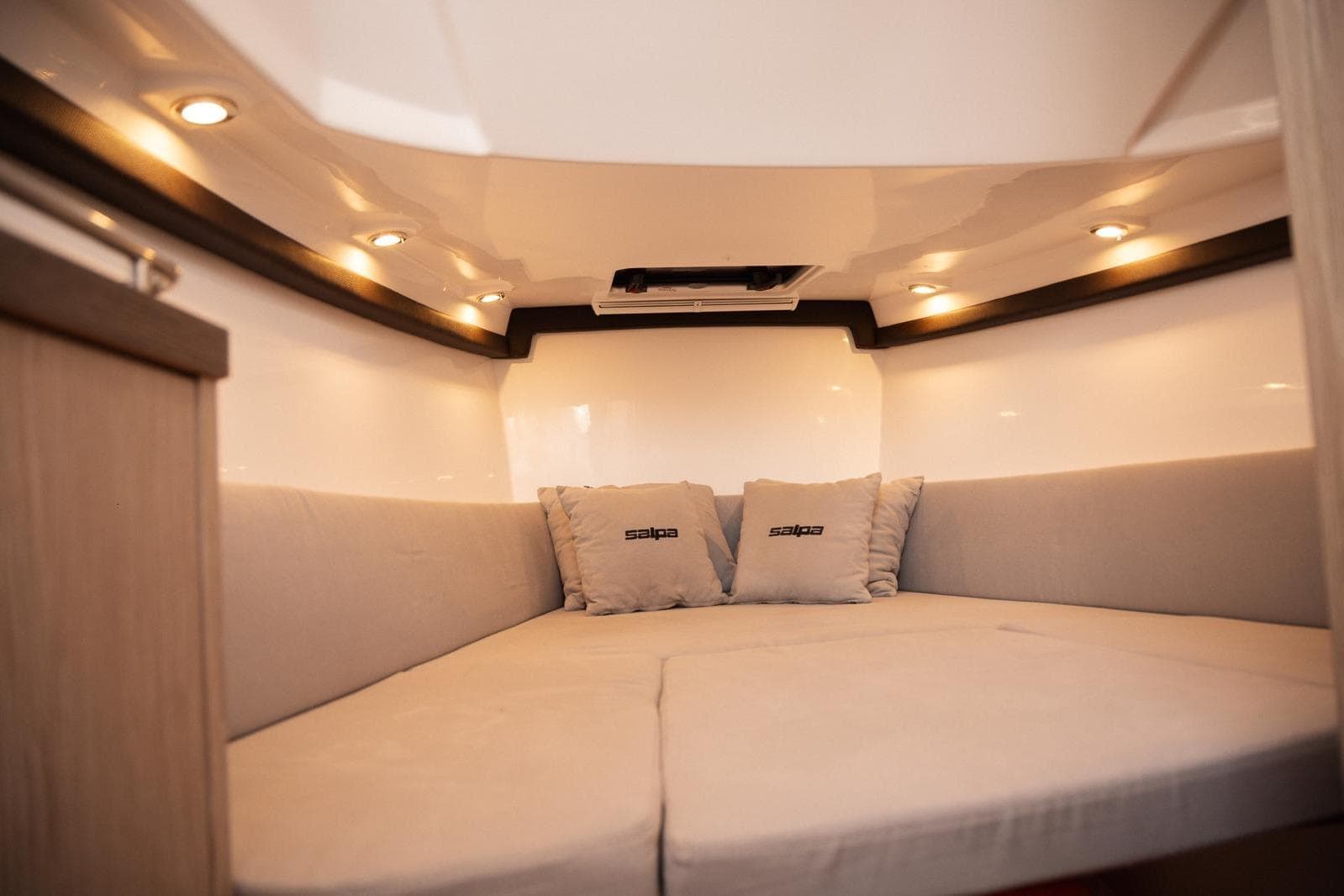 Luxurious interior cabin of 2025 Salpa SOLEIL 33 with cozy seating and ambient lighting.