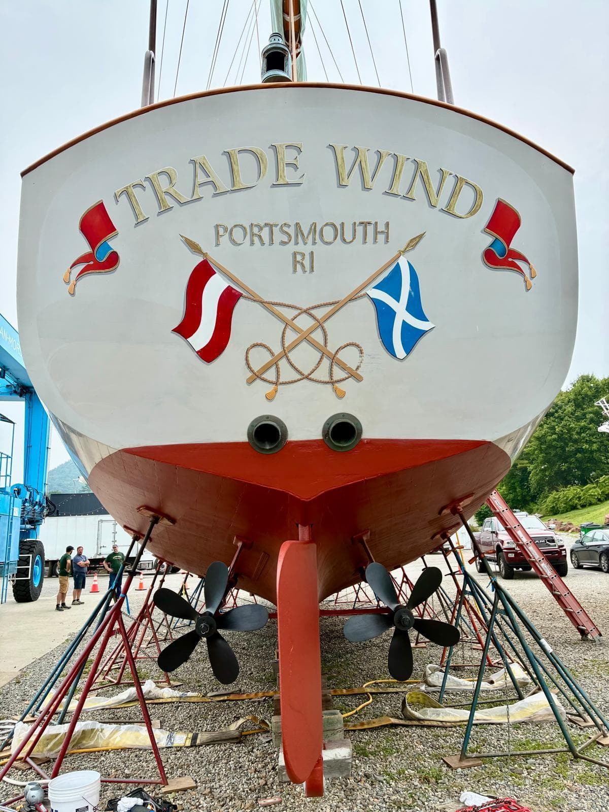 Sailboat "Trade Wind" in Portsmouth, RI, Alden Custom Design, 1938, with nautical flags and propellers.