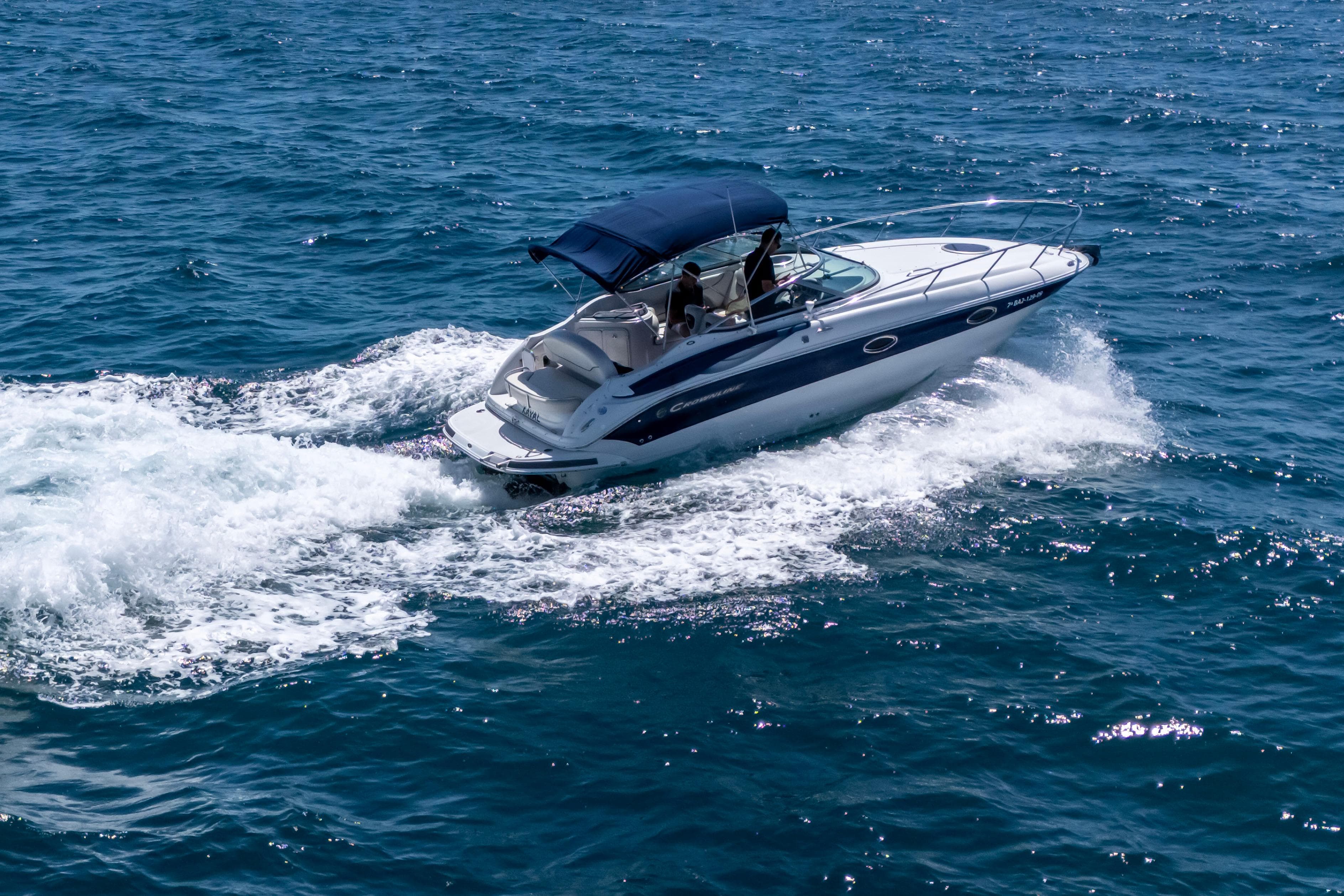 2007 Crownline 250 CR boat cruising on open blue water.