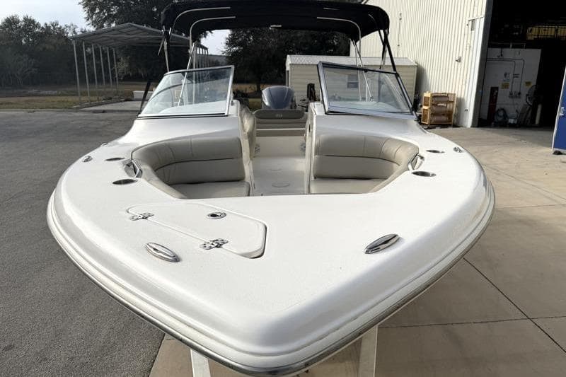 2022 Key West 239 DFS boat with open bow seating, docked outdoors.