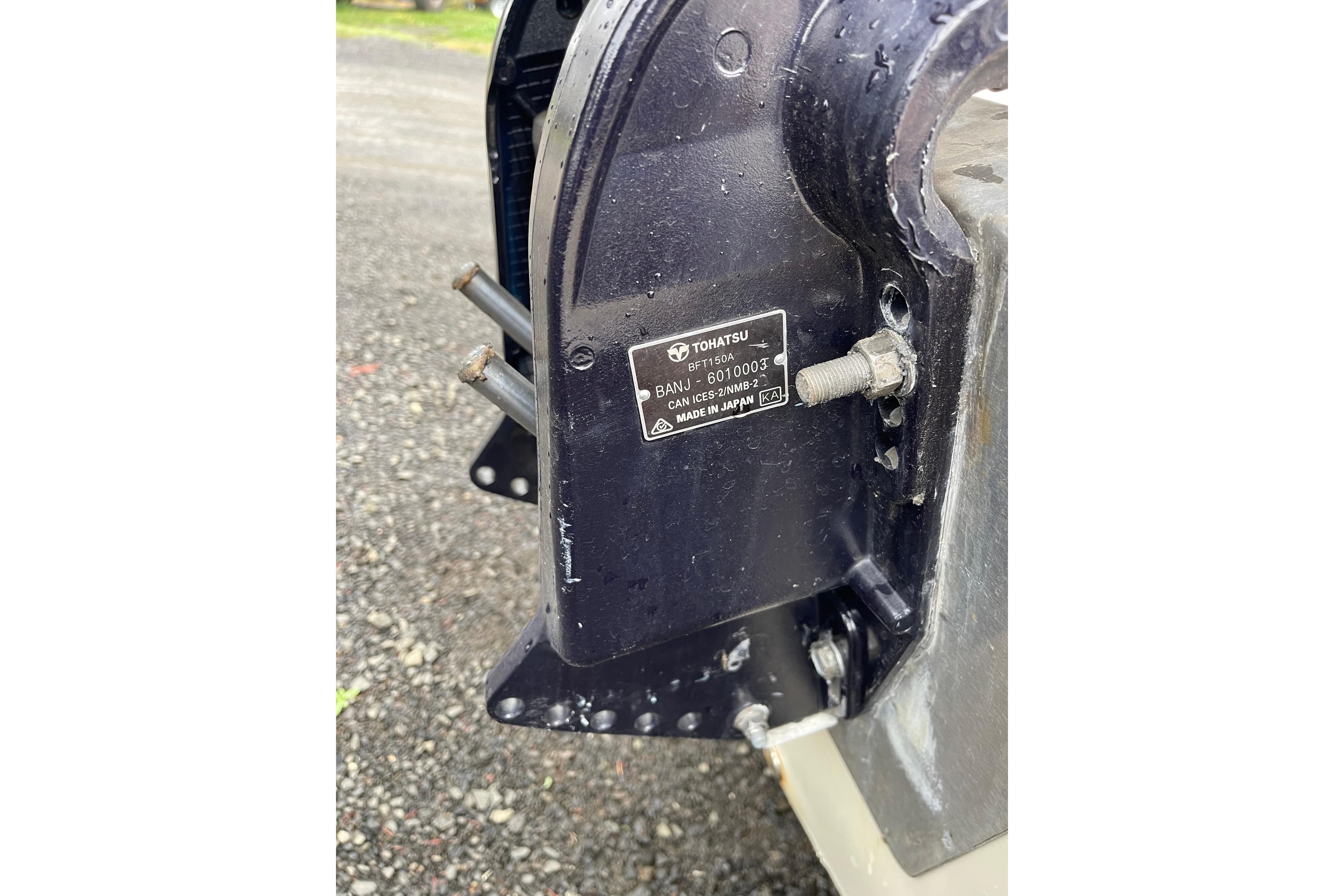 Close-up of a Tohatsu engine part on a 2004 Triumph 191 Fish & Ski boat.
