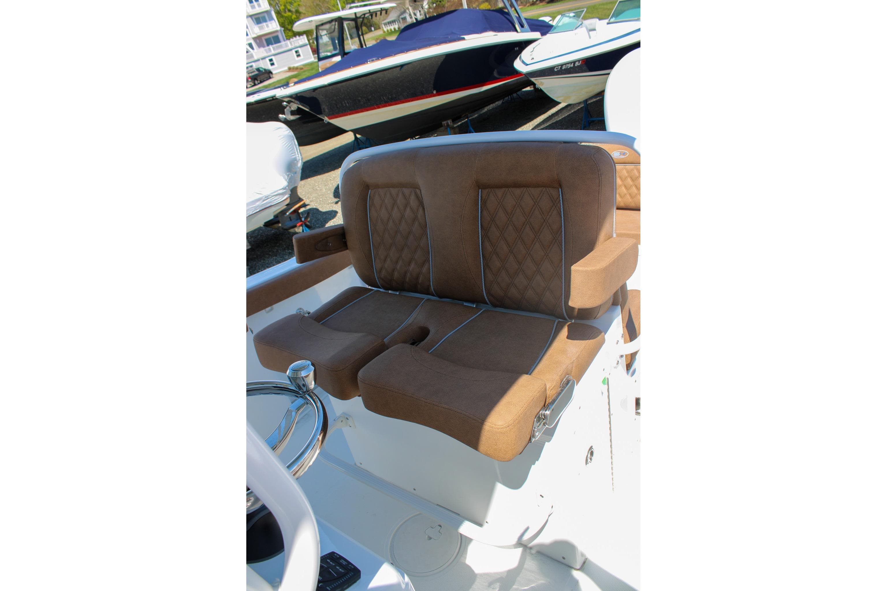 Luxurious seating on 2026 Sea Hunt Ultra 255 SE boat, featuring brown cushioned upholstery.