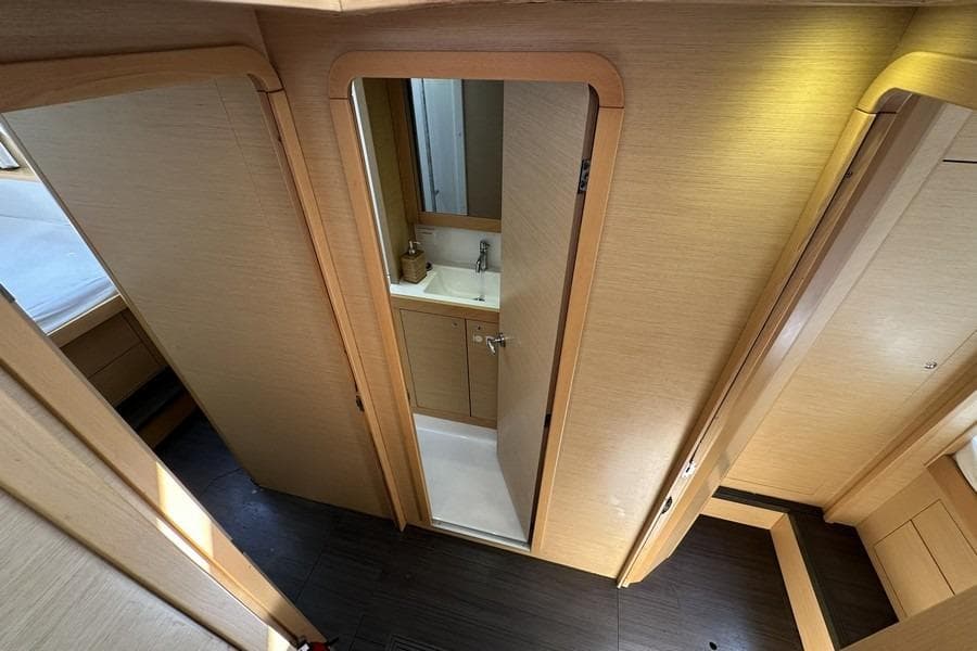 Interior of 2013 Lagoon 39 yacht showing bathroom and wooden cabinetry.