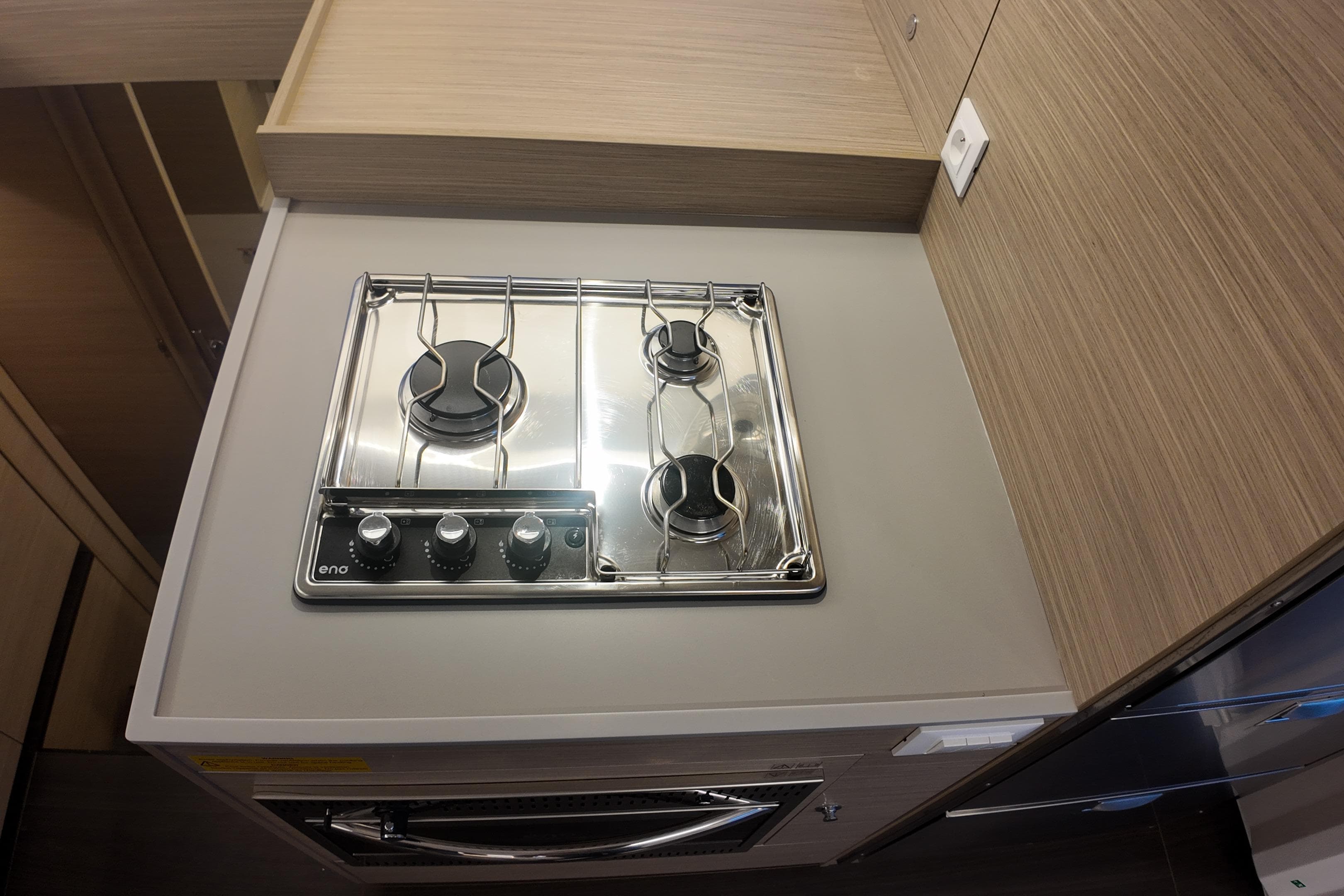 Modern kitchen stove in 2026 Lagoon 38 yacht, featuring sleek design and efficient burners.