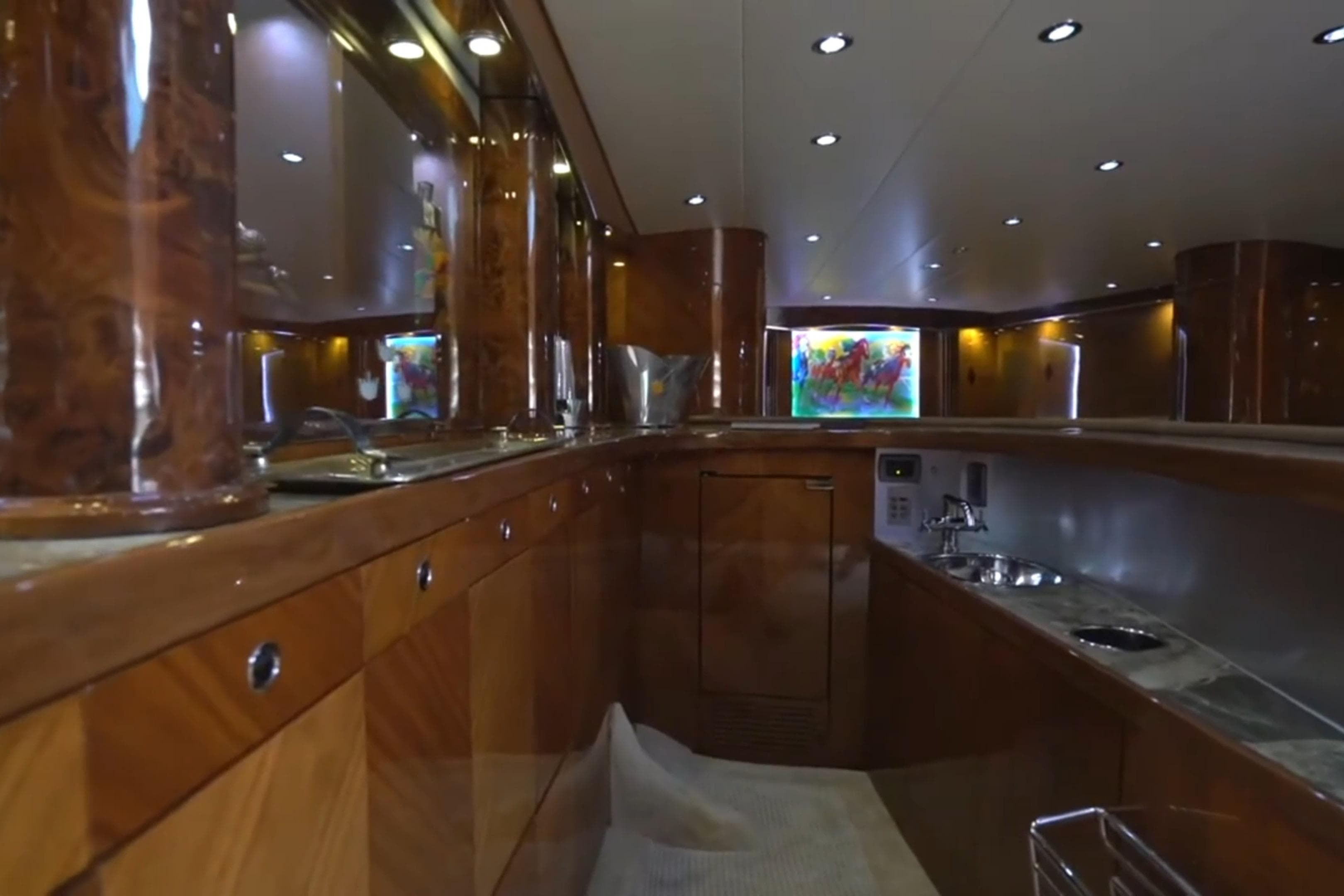Luxurious interior of a 1987 Magnum 70 Convertible yacht with polished wood finishes.