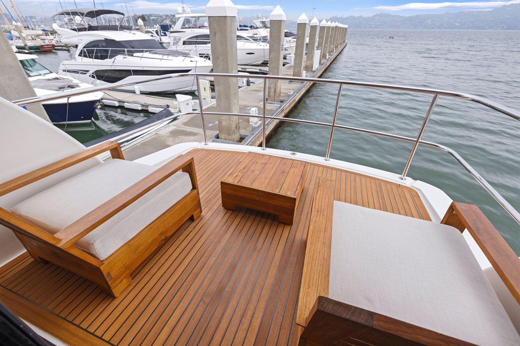 Luxury Maritimo M50 yacht deck with wooden seating, docked at marina, 2014 model.