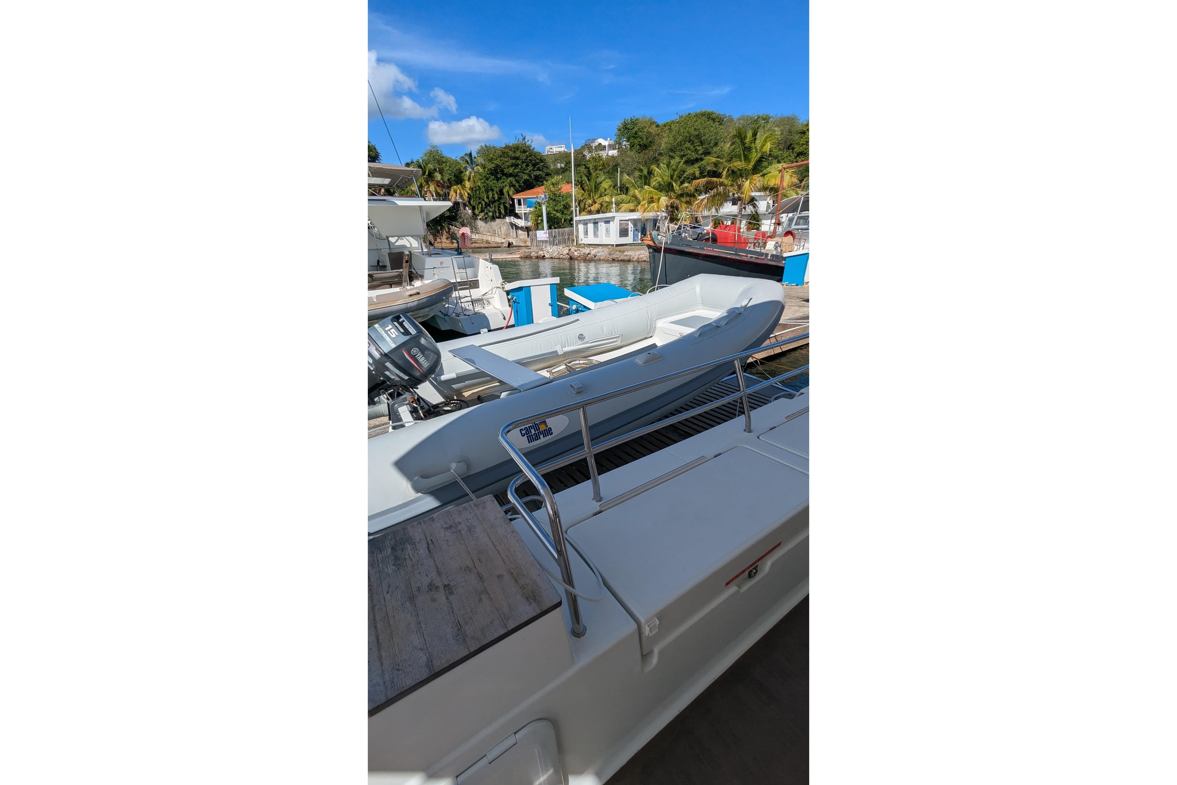 Fountaine Pajot Saona 47 catamaran, 2020 model, docked with inflatable boat on deck.