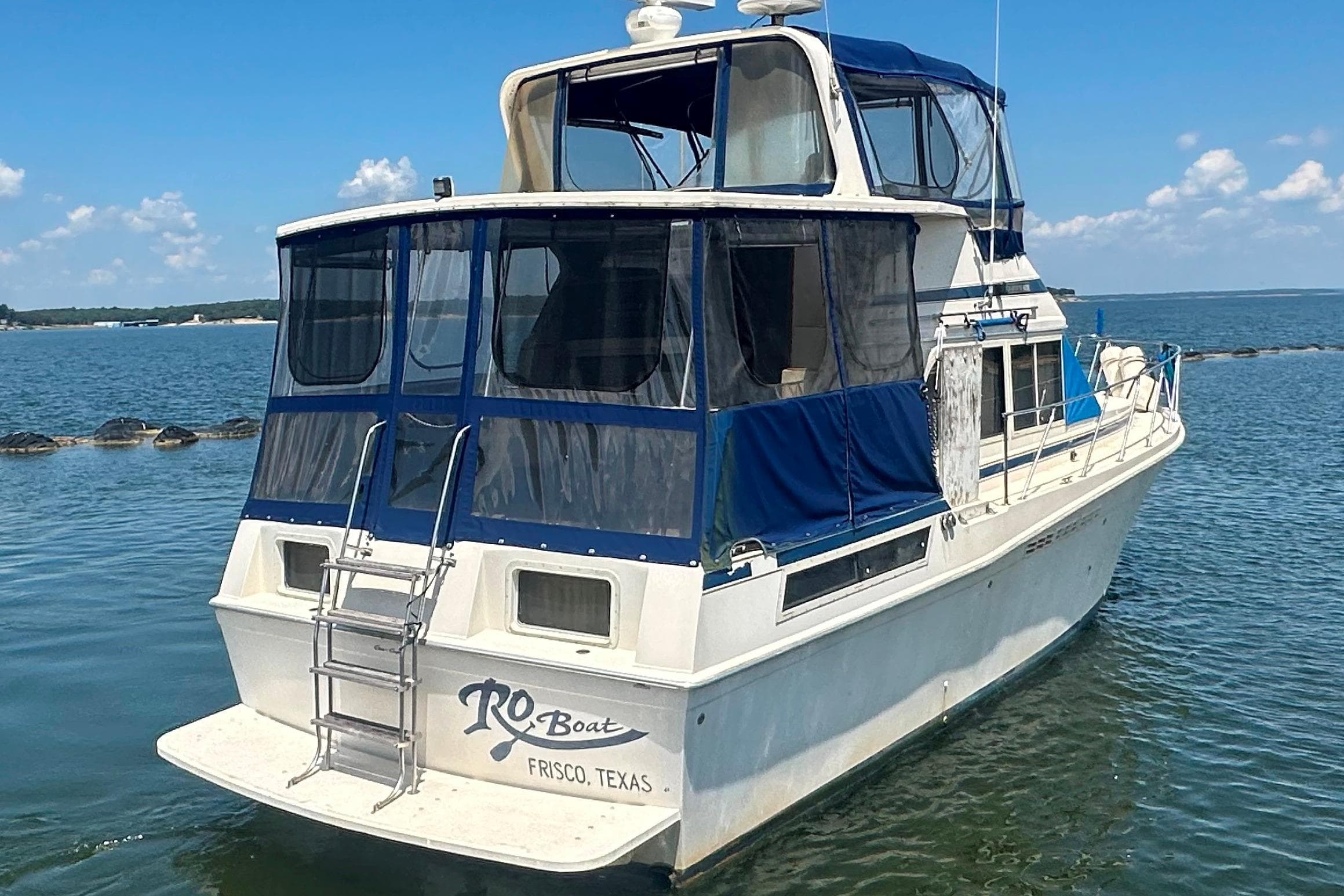 1985 Chris-Craft 426 Catalina yacht on water, Frisco, Texas, with blue canopy.