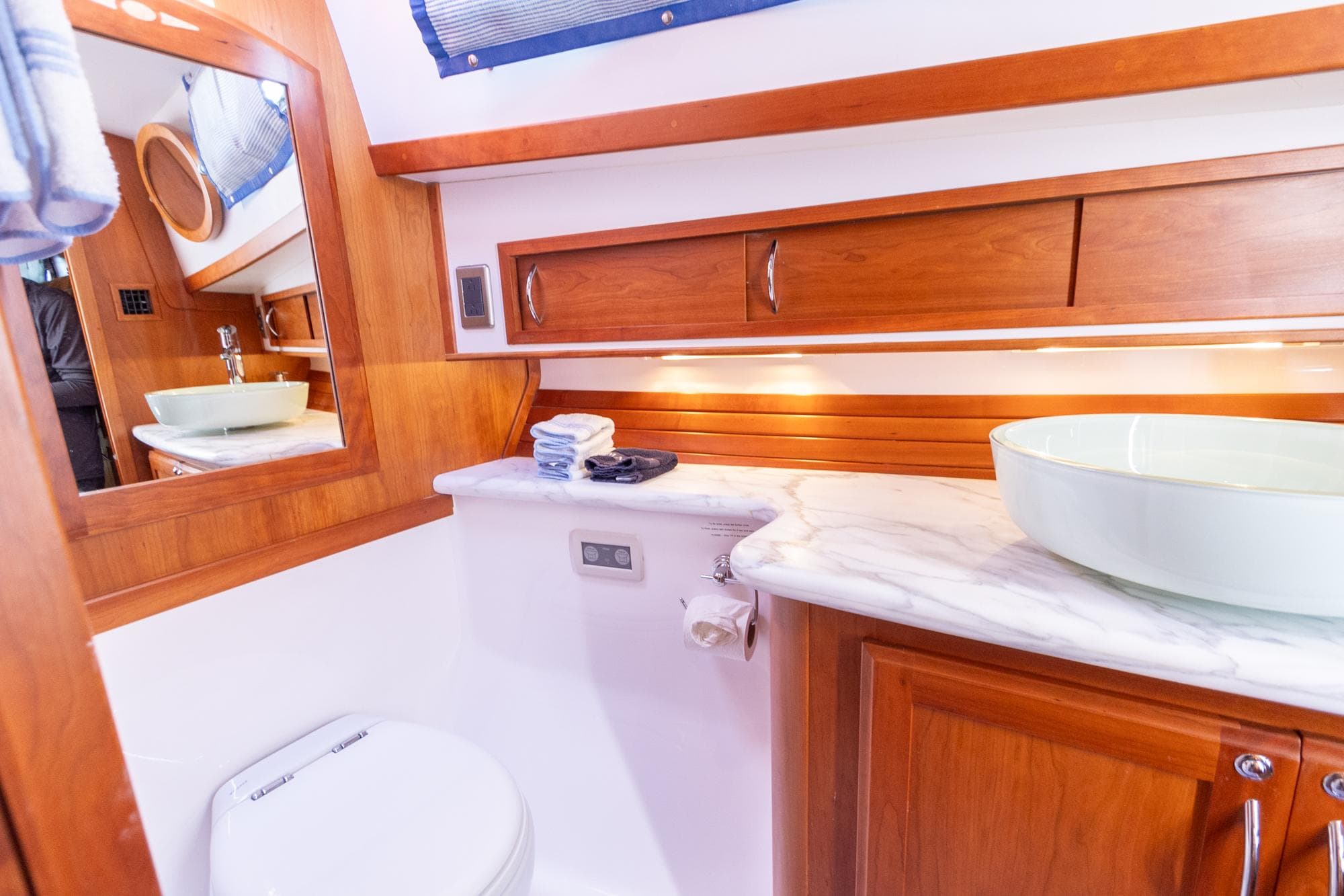 Luxurious bathroom in 2009 Sabre 52 Express yacht with wooden cabinetry and modern fixtures.