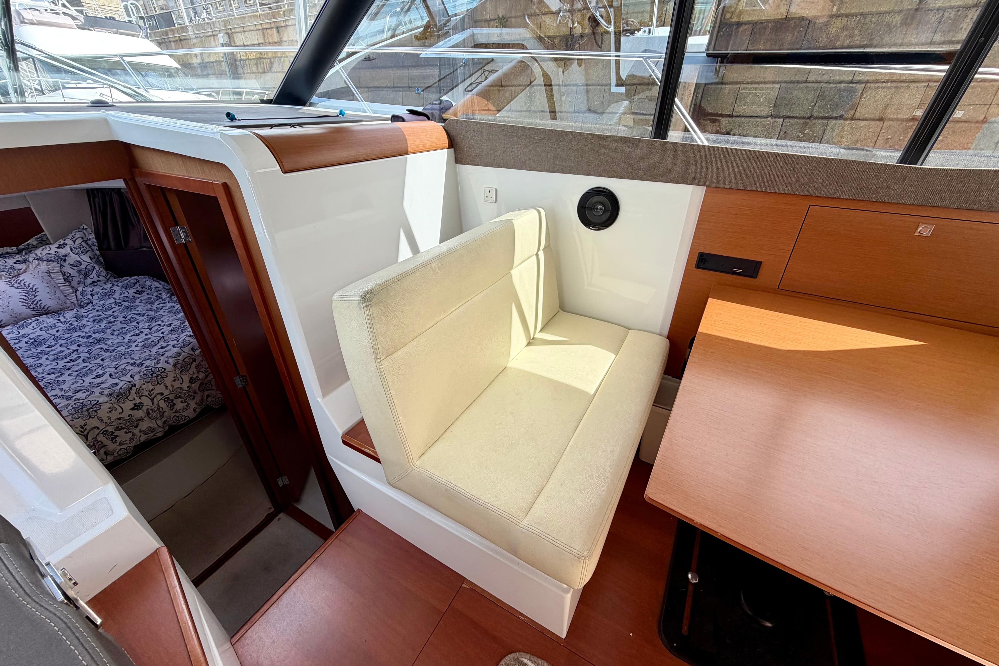 Interior of 2013 Jeanneau NC 9 boat with seating and cabin area.