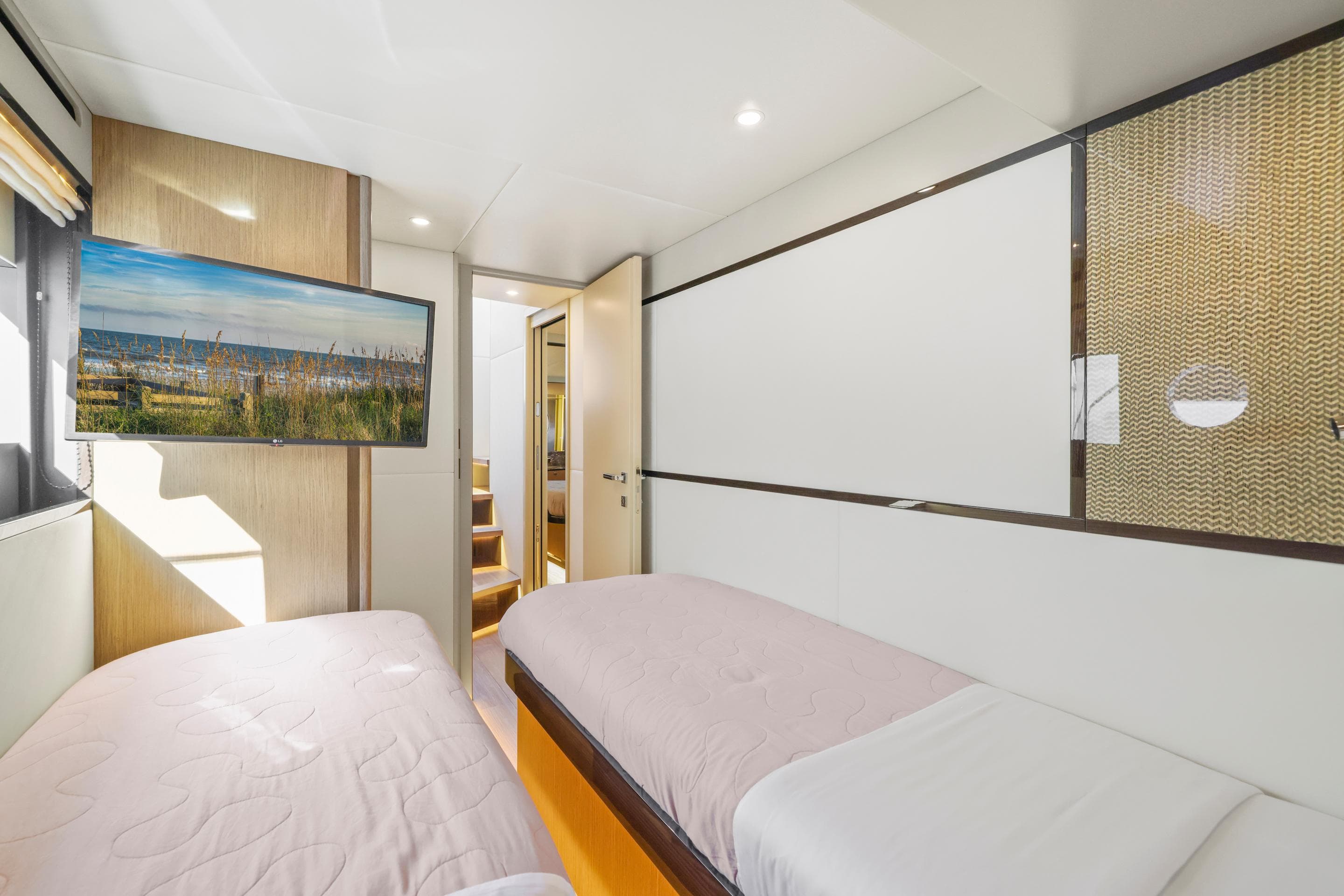 Interior of Absolute 60 Fly yacht, 2026, featuring twin beds.