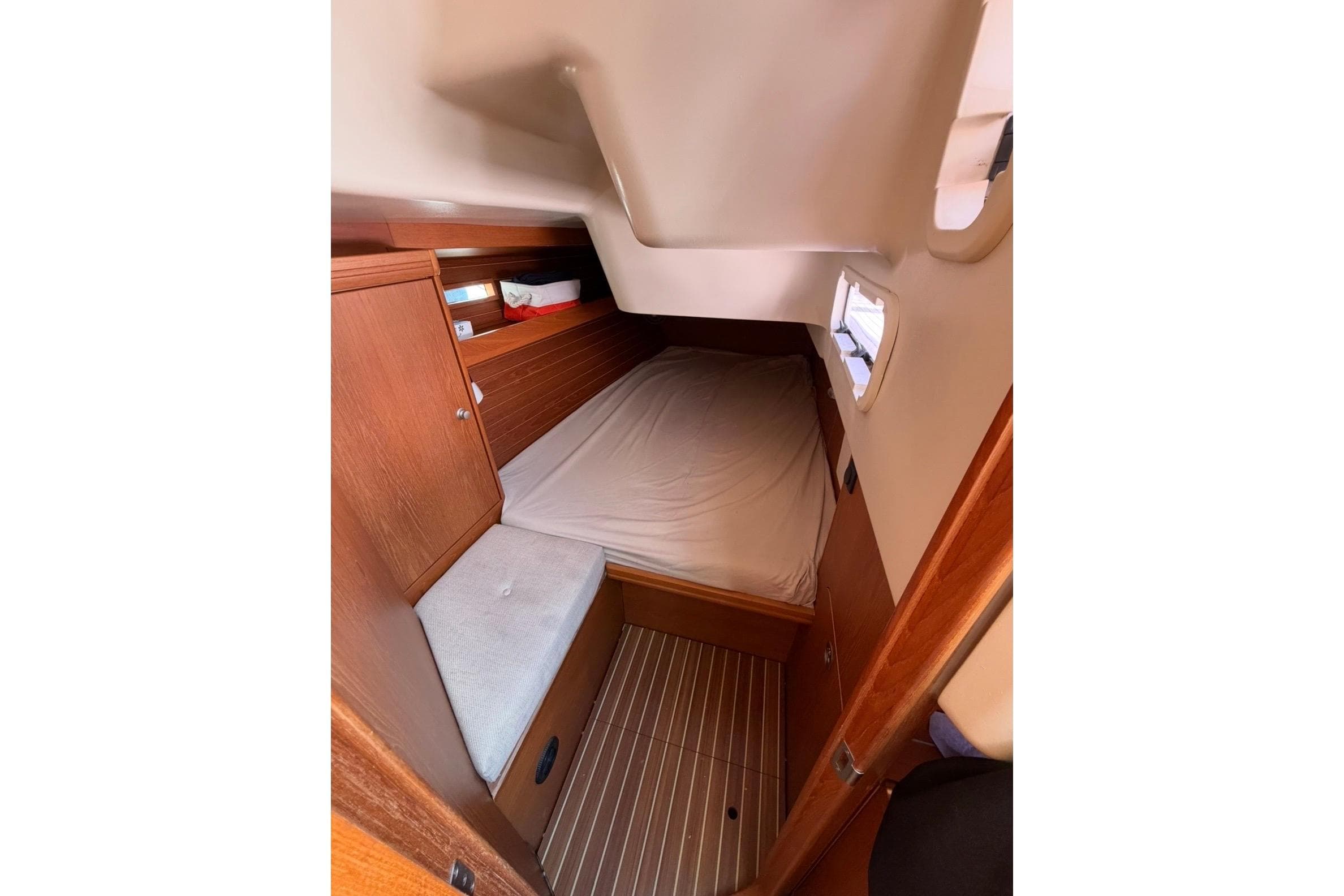 Cozy cabin interior of 2011 Dehler 45 yacht with wooden furnishings.