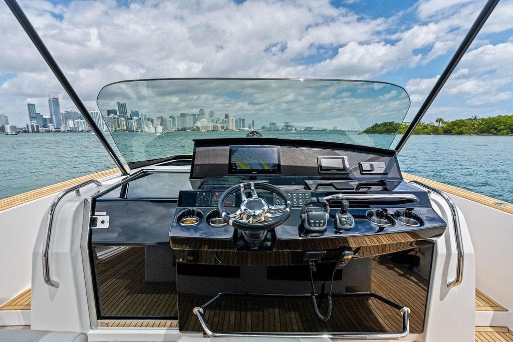 Cockpit view of 2021 Pardo 43 yacht with city skyline in background.