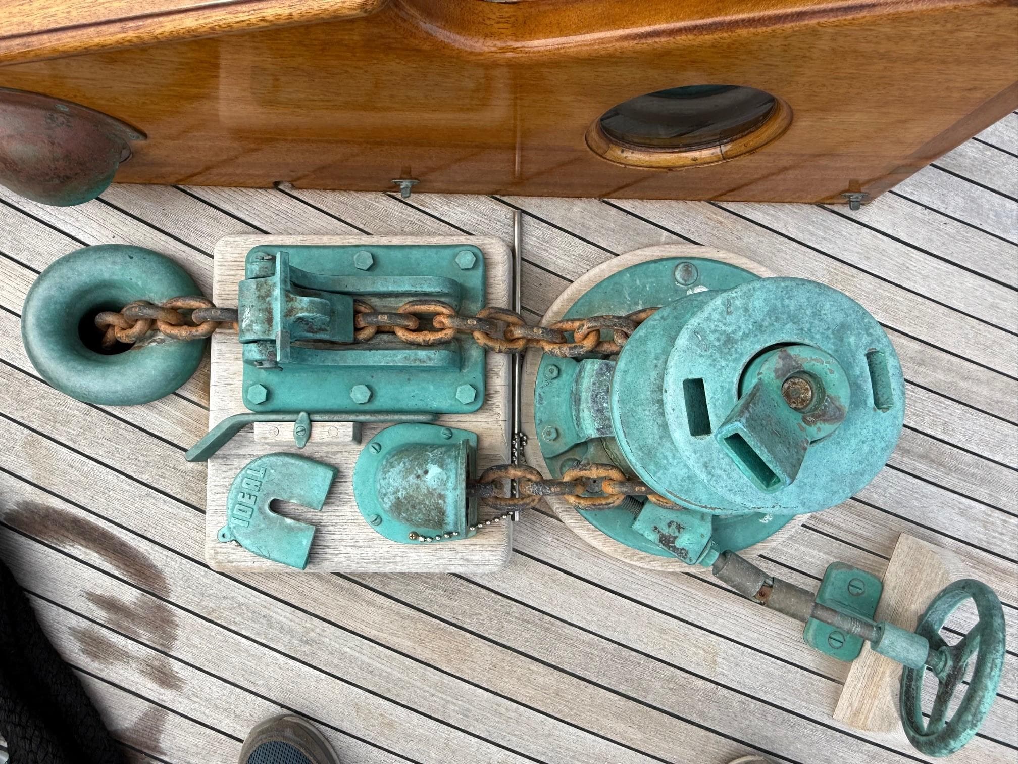 Vintage ship's anchor windlass on wooden deck, Alden Custom Design, 1938.