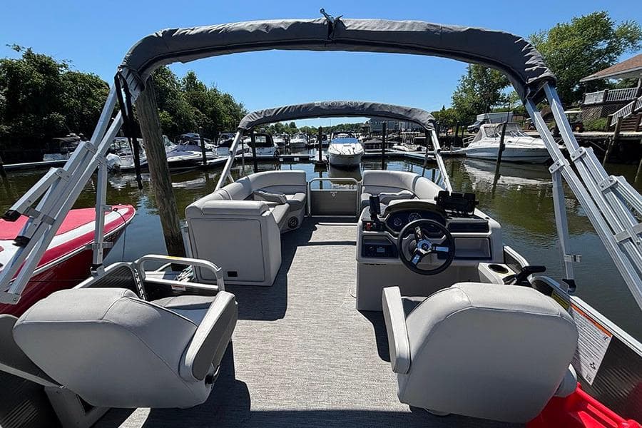 2022 Godfrey Sweetwater 2286 SBX pontoon boat interior at a marina.