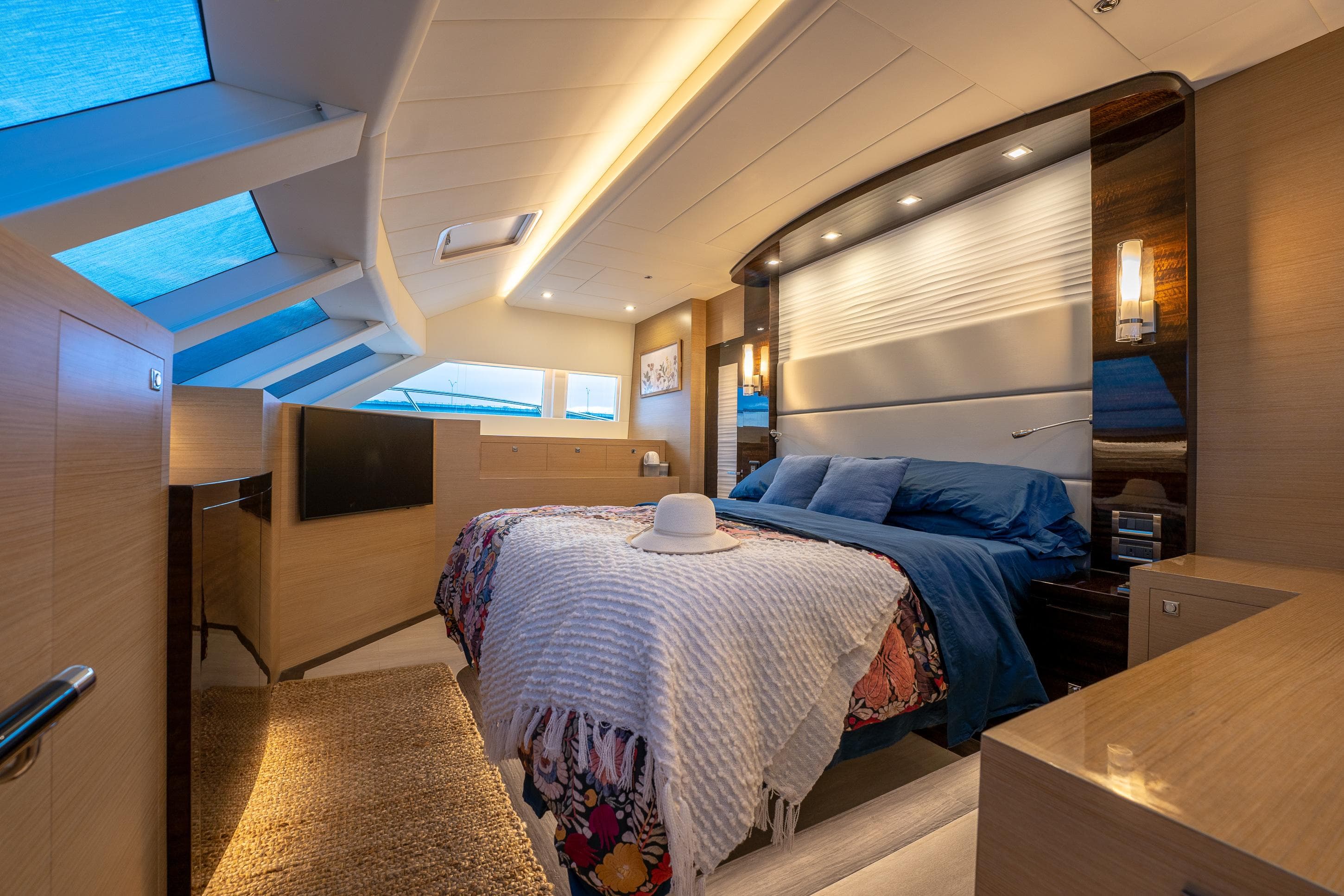 Luxurious bedroom interior on 2020 Horizon PC60 yacht with modern design and skylights.