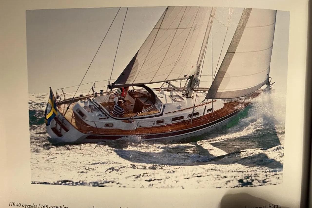 Sailing yacht Hallberg-Rassy 40C, 2008 model, navigating through ocean waves.