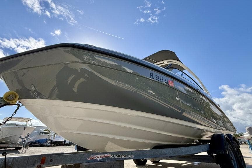 2020 Yamaha Boats AR210 on trailer under clear blue sky.