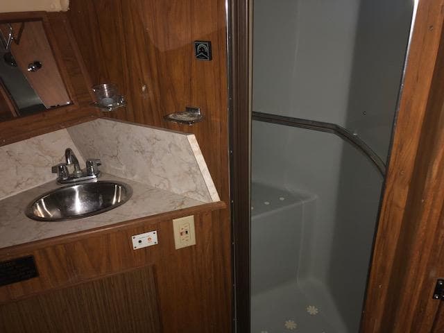 1983 Sea Ray 390 Sport Fisherman bathroom with sink and shower.