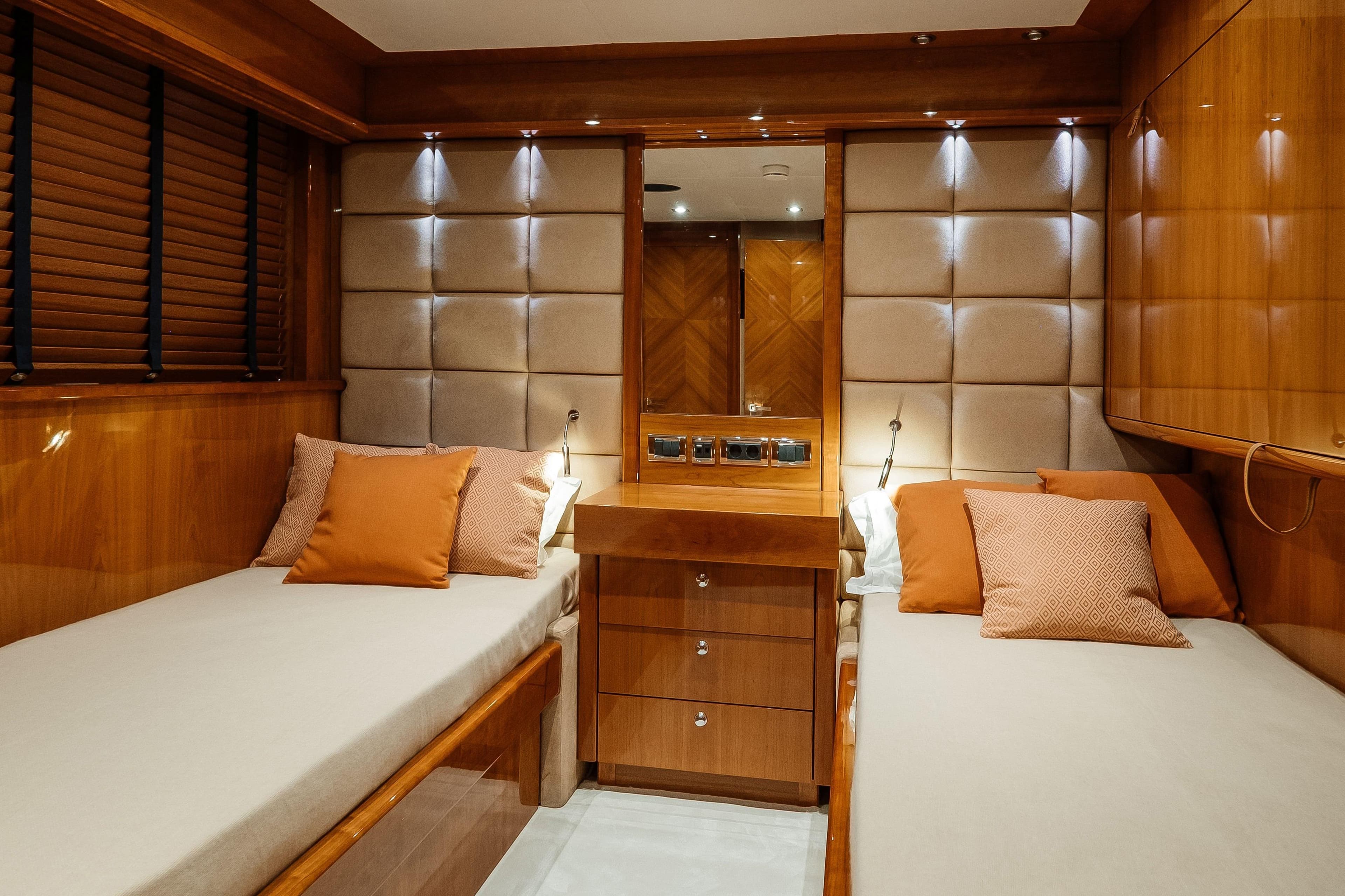Luxurious twin cabin interior on 2009 Sunseeker 30 Metre Yacht with elegant wood finishes.