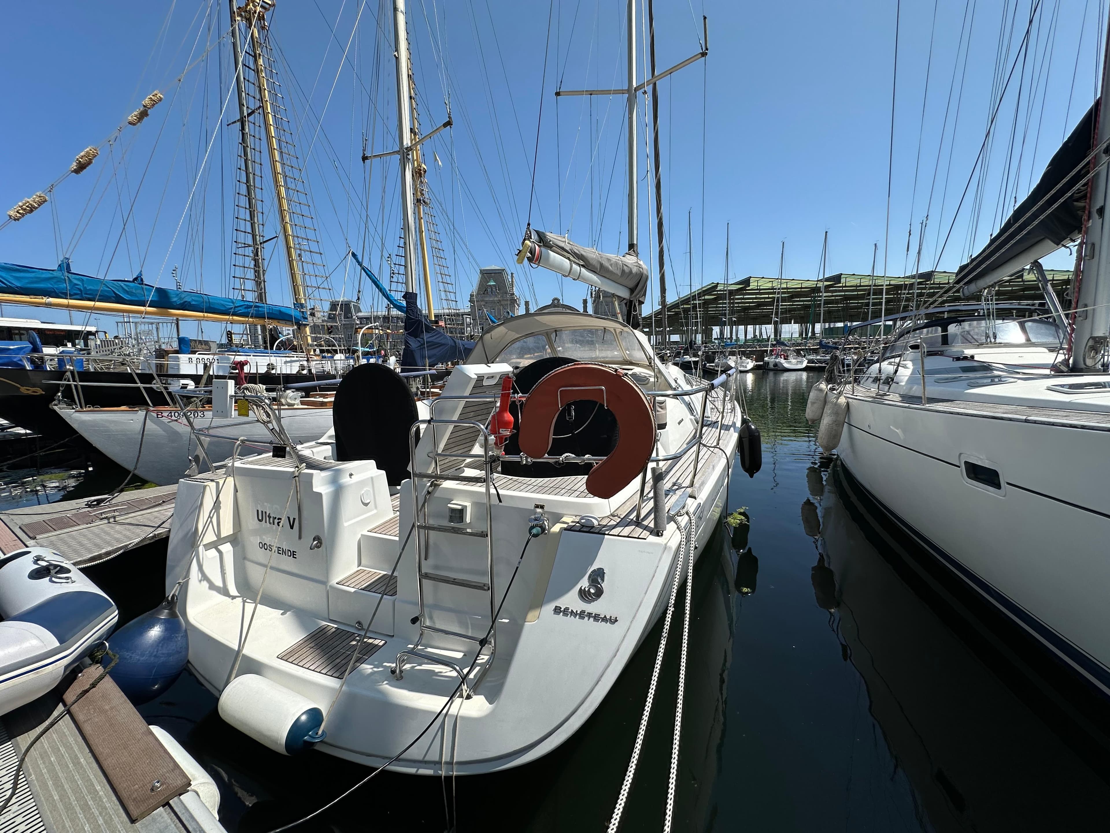 2007 Beneteau Oceanis 43 sailboat docked in a marina, surrounded by other vessels.