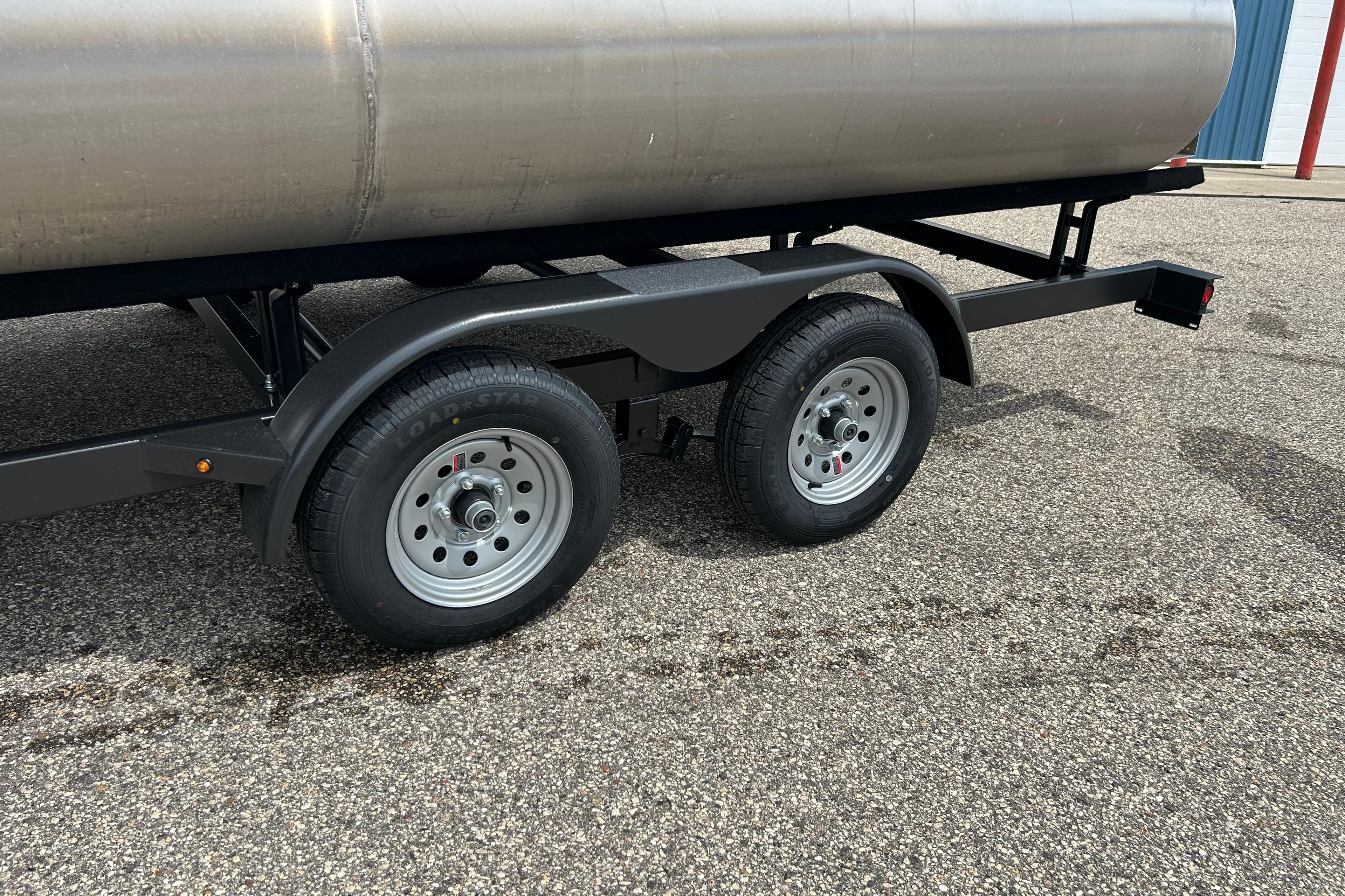 Trailer wheels of a 2022 Starcraft CX 21 C on asphalt surface.