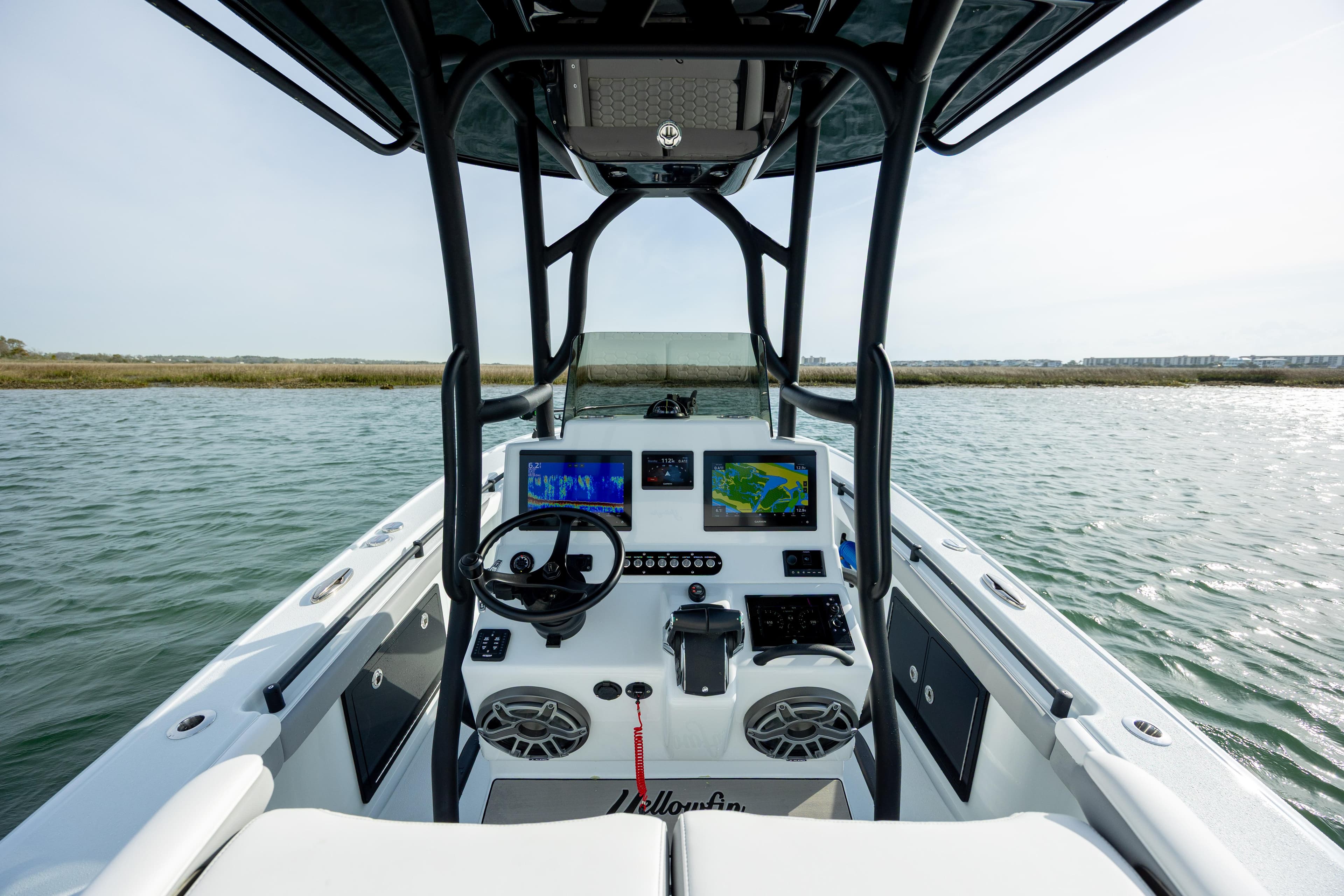 2025 Yellowfin 26 Hybrid boat dashboard with advanced navigation systems on open water.