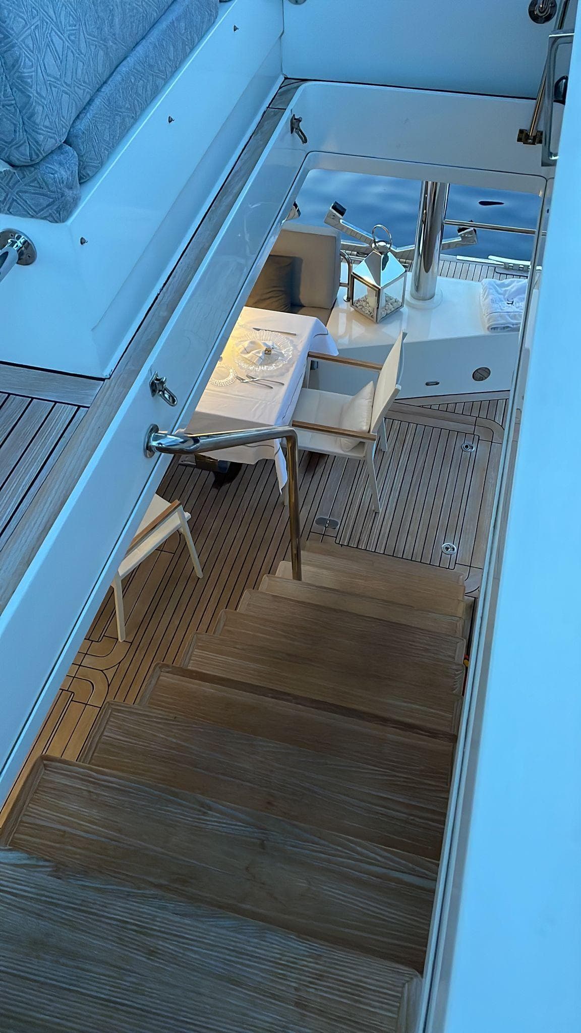 Staircase on 2015 Sunreef 74 yacht leading to elegant dining area.
