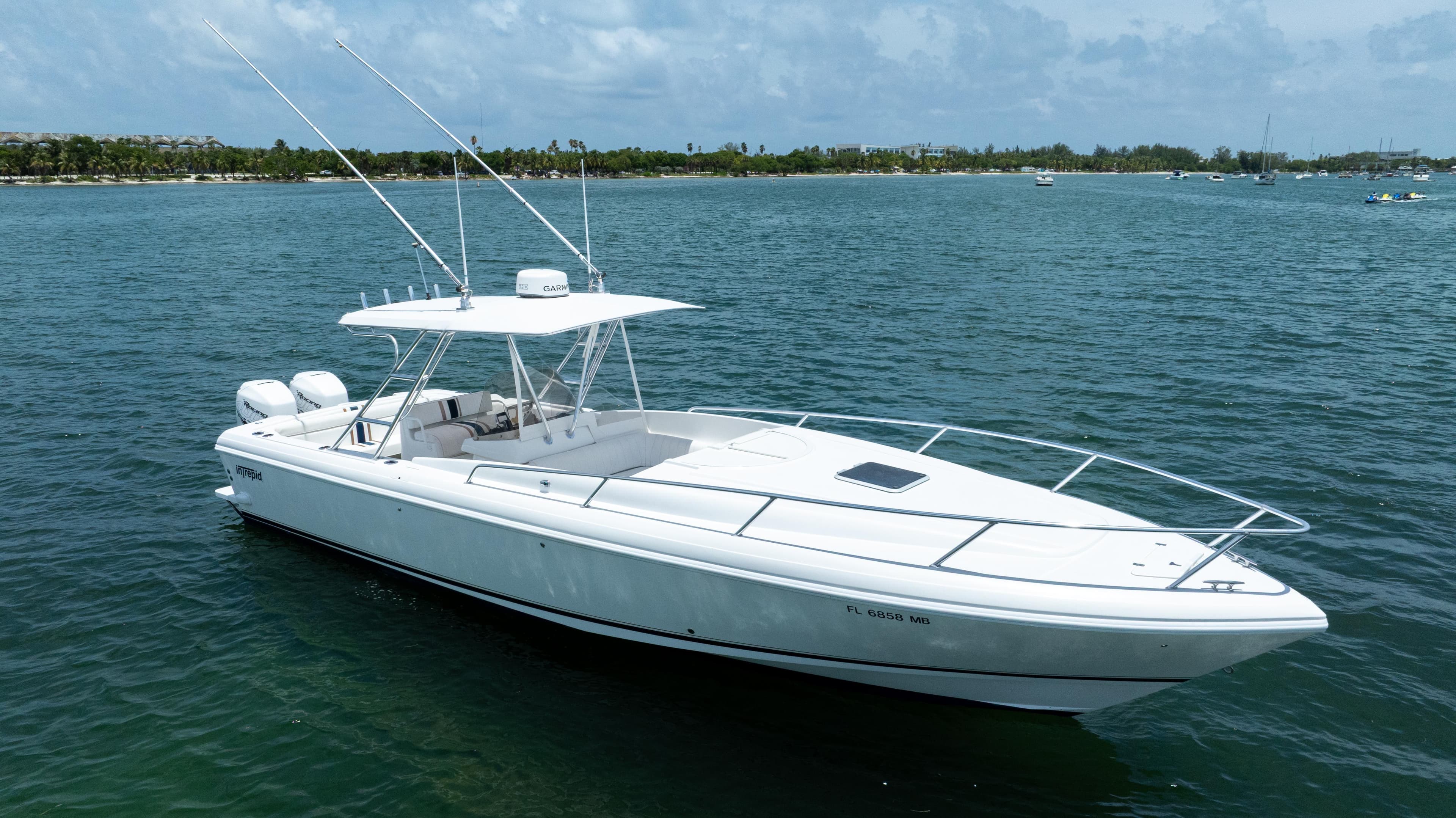 1999 Intrepid 35 boat on calm water, clear sky, distant shoreline.