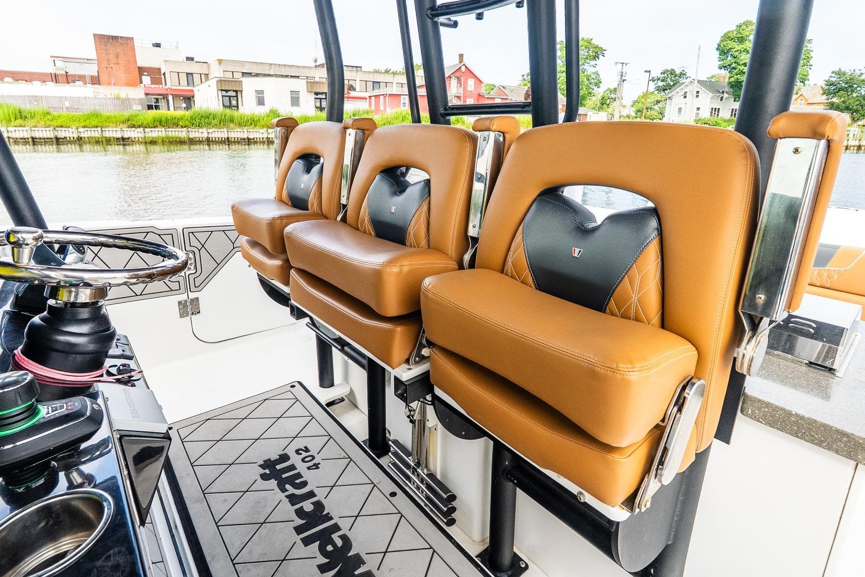 2021 Wellcraft 402 Fisherman boat interior with luxurious tan seating and modern steering console.