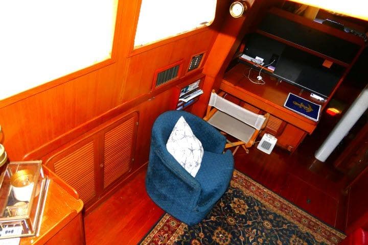 Interior of 1982 Ta Shing Mason 63 yacht with cozy seating and wooden decor.