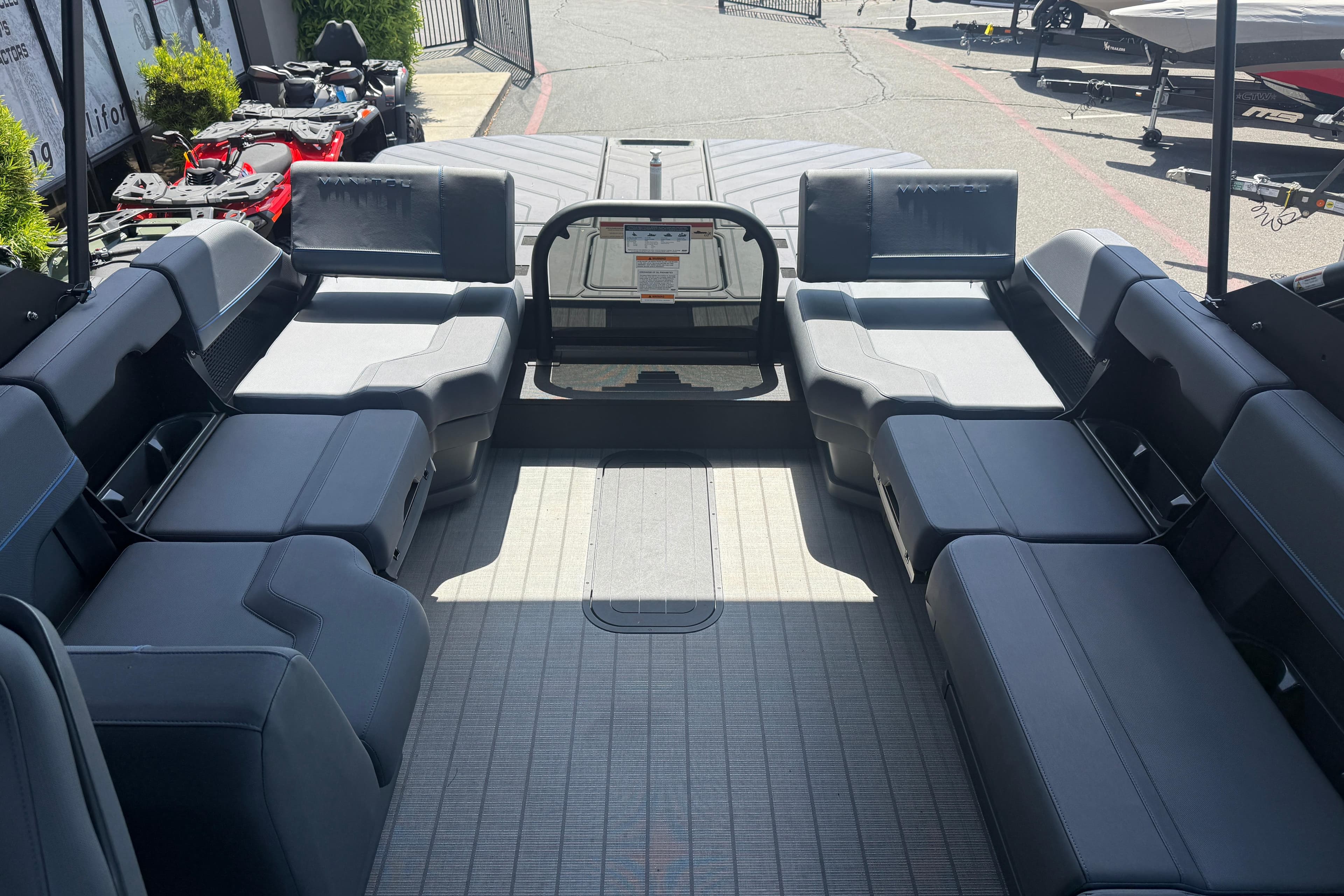 Interior of 2025 Manitou Explore Dual Engine boat with spacious seating and modern design.