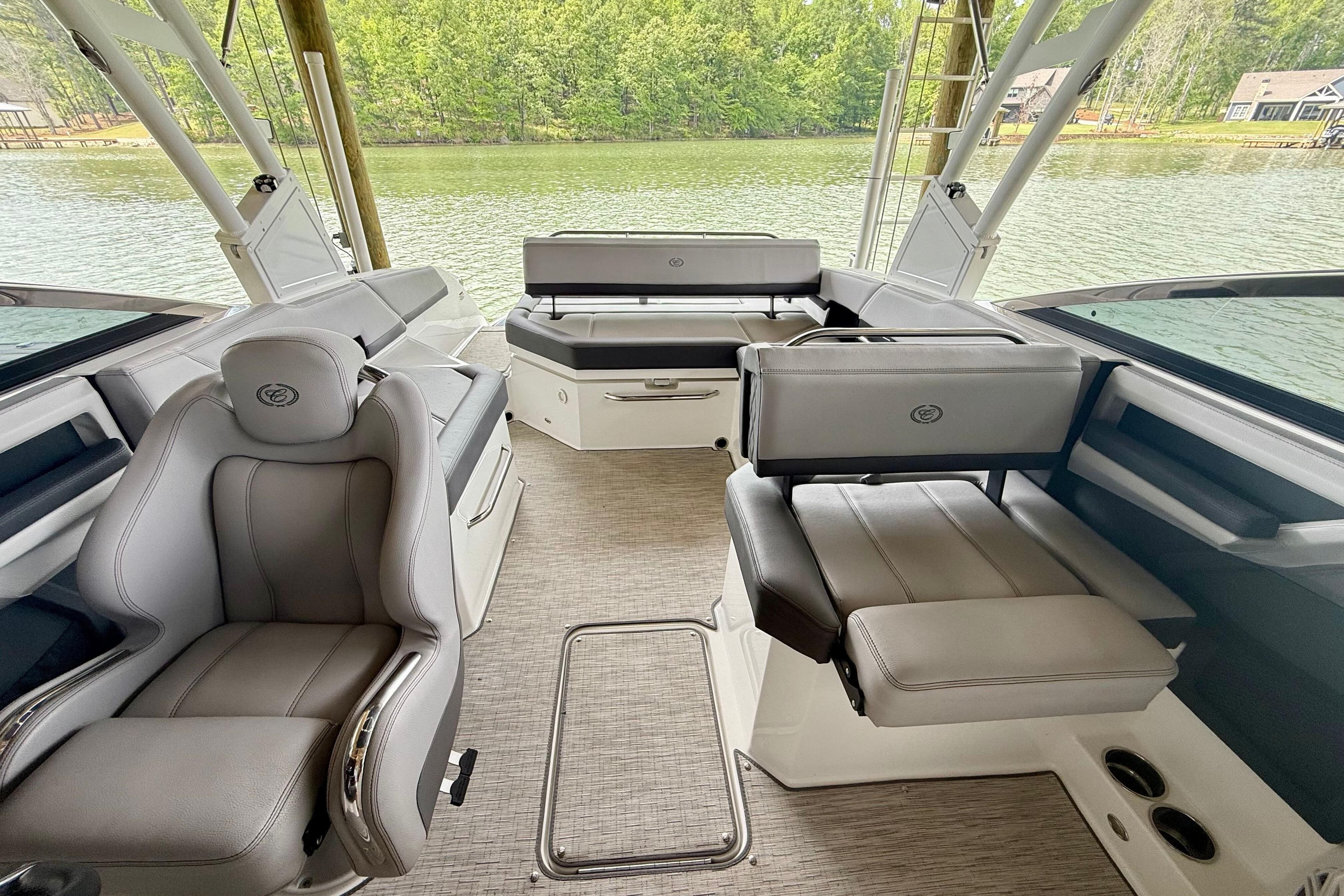 2023 Cobalt R6 boat interior with luxurious seating and scenic lake view.