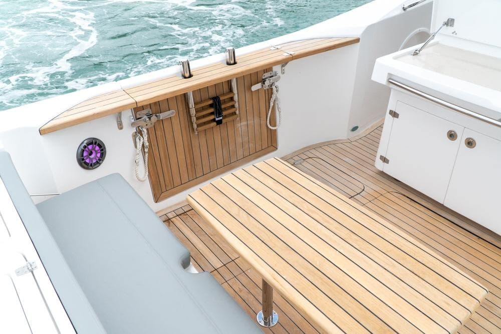 Luxury deck of 2025 Fishing Raptor 390 Solarium with teak wood finish.