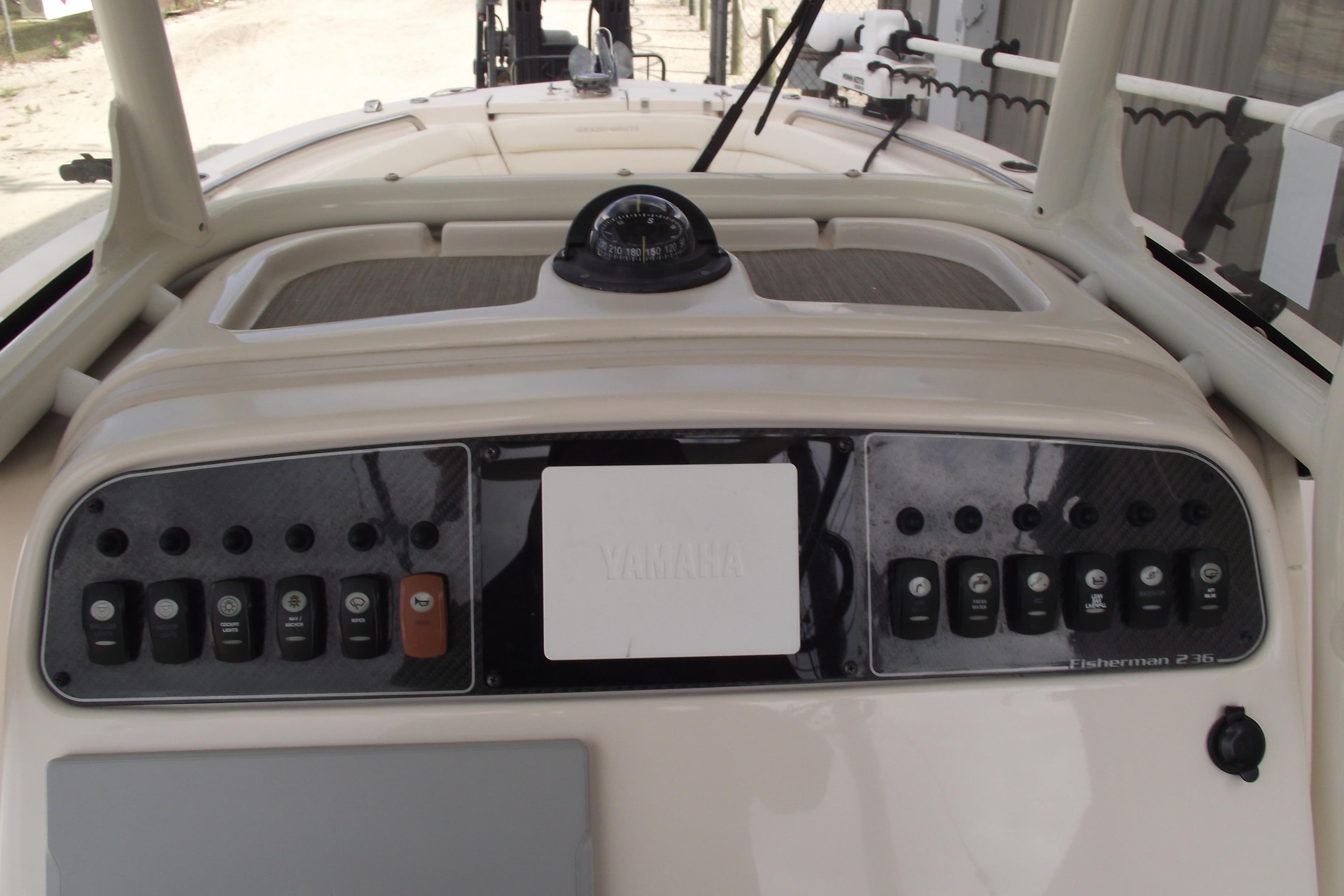 2023 Grady-White Fisherman 236 dashboard with controls and compass.