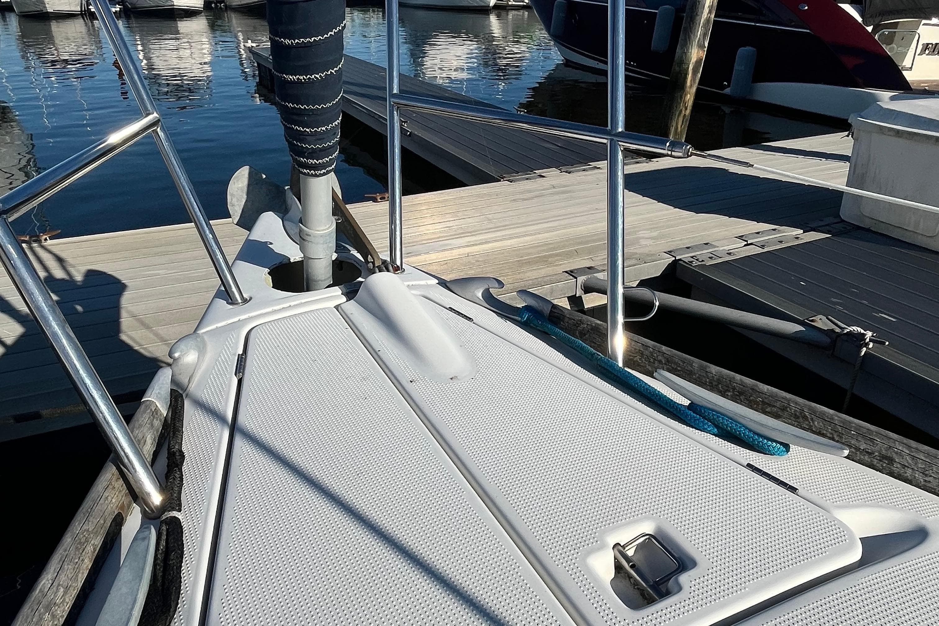 Bow of 1994 Beneteau First 35s7 sailboat docked at marina.