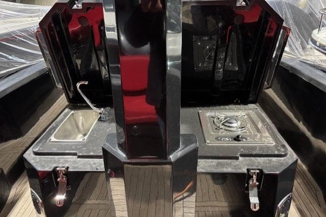Outdoor kitchen setup on 2018 Lomac Gran Turismo 10.5 boat with sink and stove.