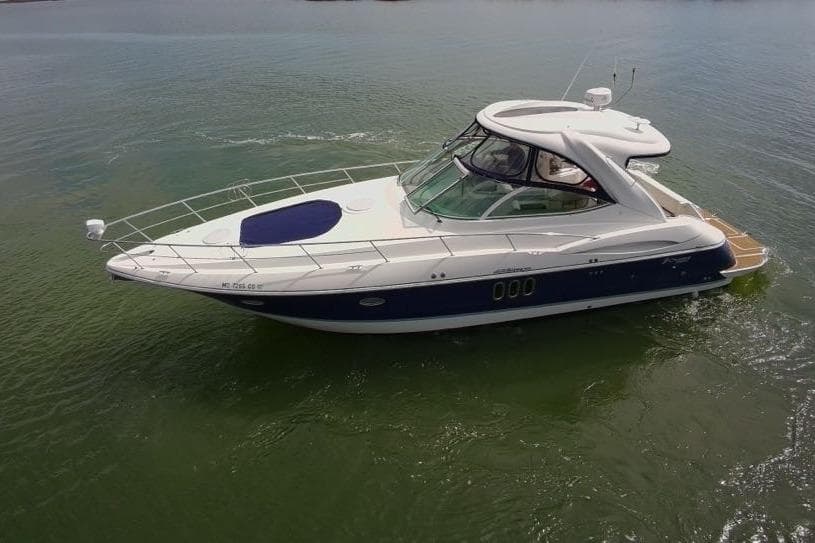 2007 Cruisers Yachts 420 Express on calm water, showcasing sleek design and luxury features.
