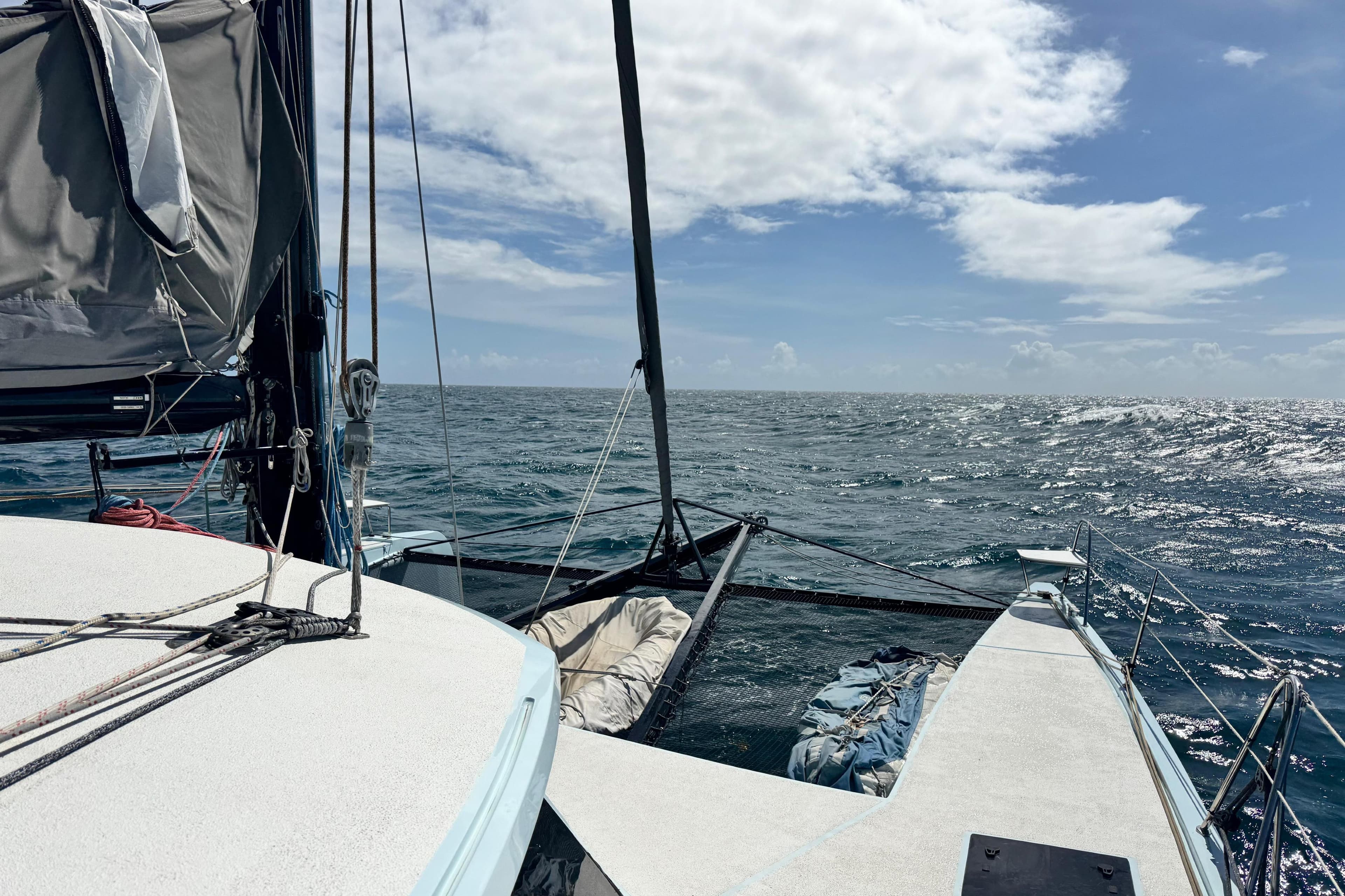 Sailing on Alibi 54 catamaran, 2011 model, under clear skies and calm ocean.