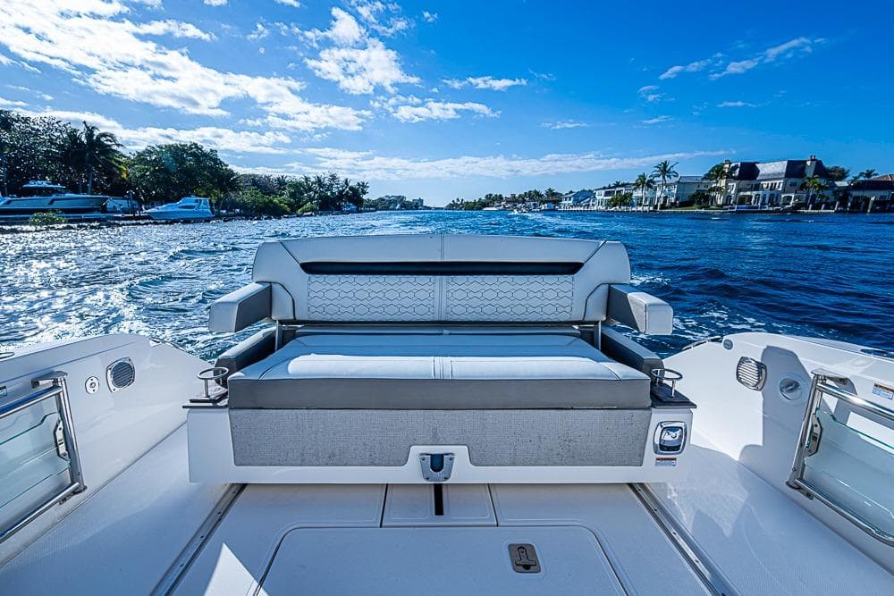 2023 Tiara Sport 34 LS boat on a sunny day, featuring luxurious seating and scenic waterfront views.