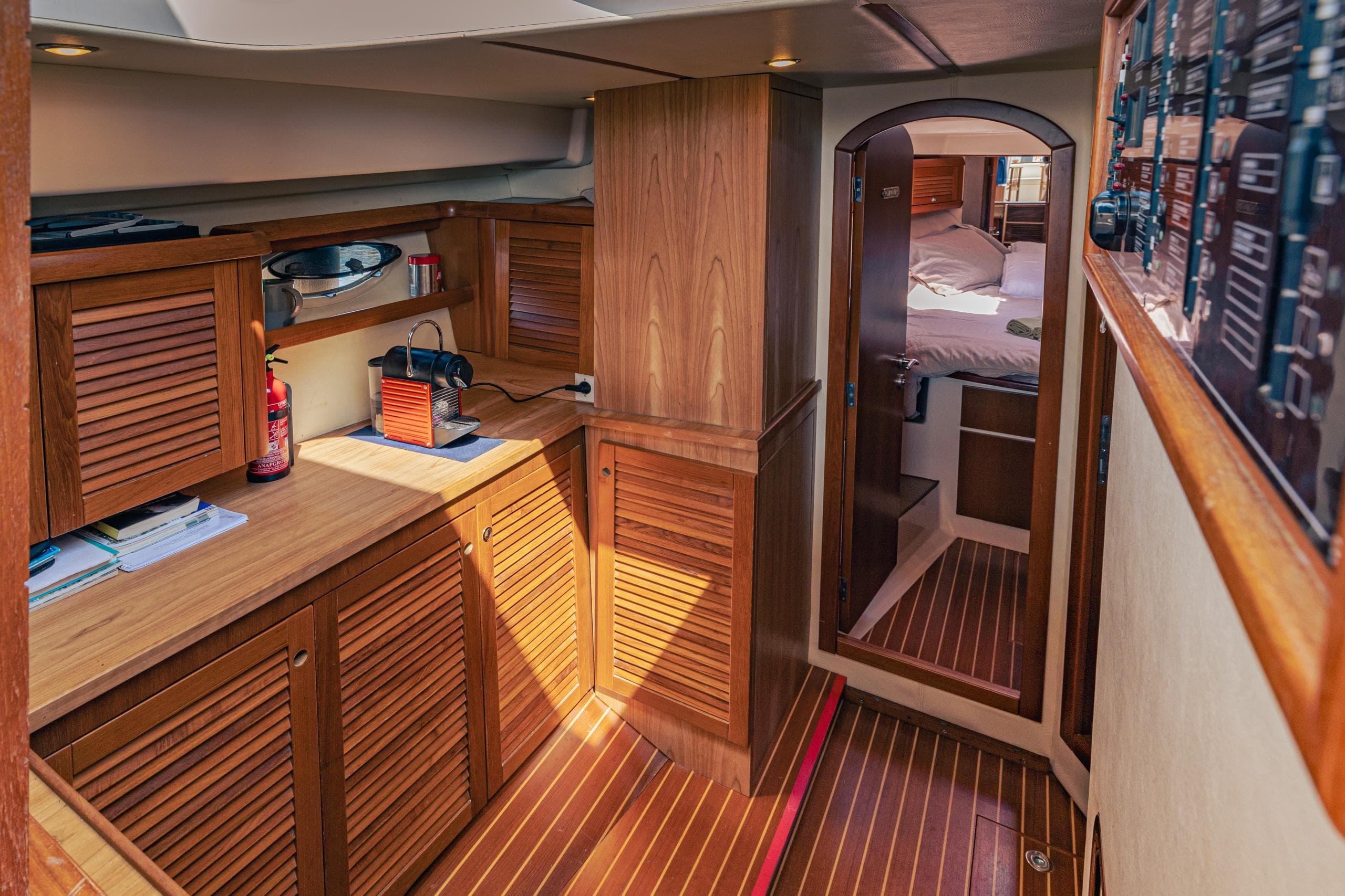Interior of 2006 Arcoa Mystic 39 yacht with wooden cabinetry and cozy cabin.