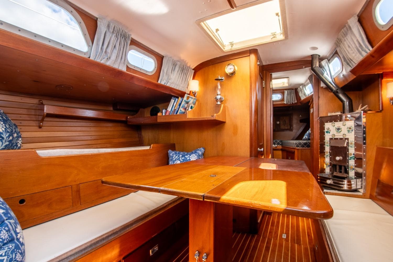 Interior of a 1971 Hinckley Bermuda 40 Custom Yawl, featuring wooden furnishings and cozy seating.