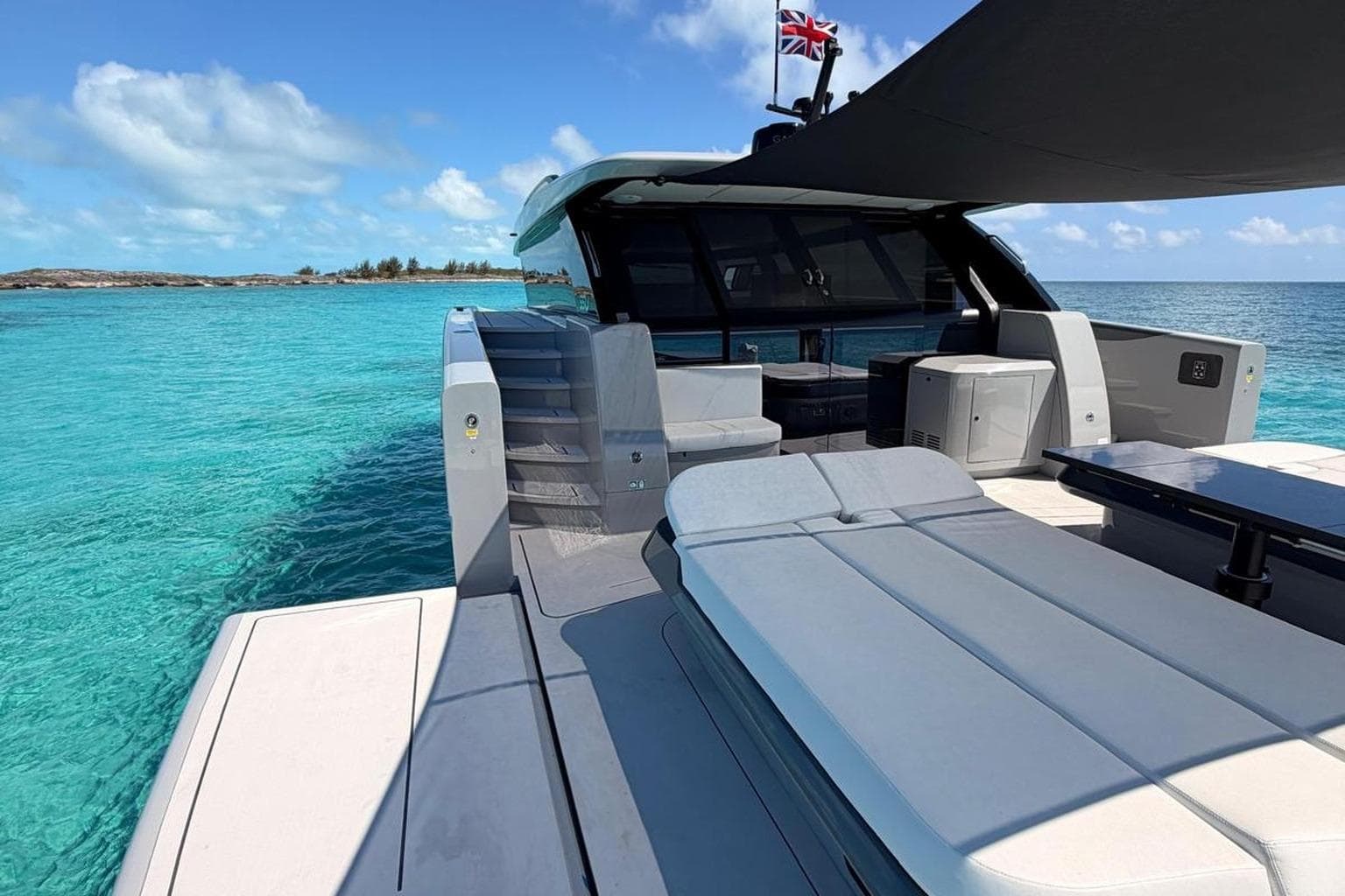 Luxurious Sunreef Ultima 55 yacht, 2026 model, anchored in clear turquoise waters.