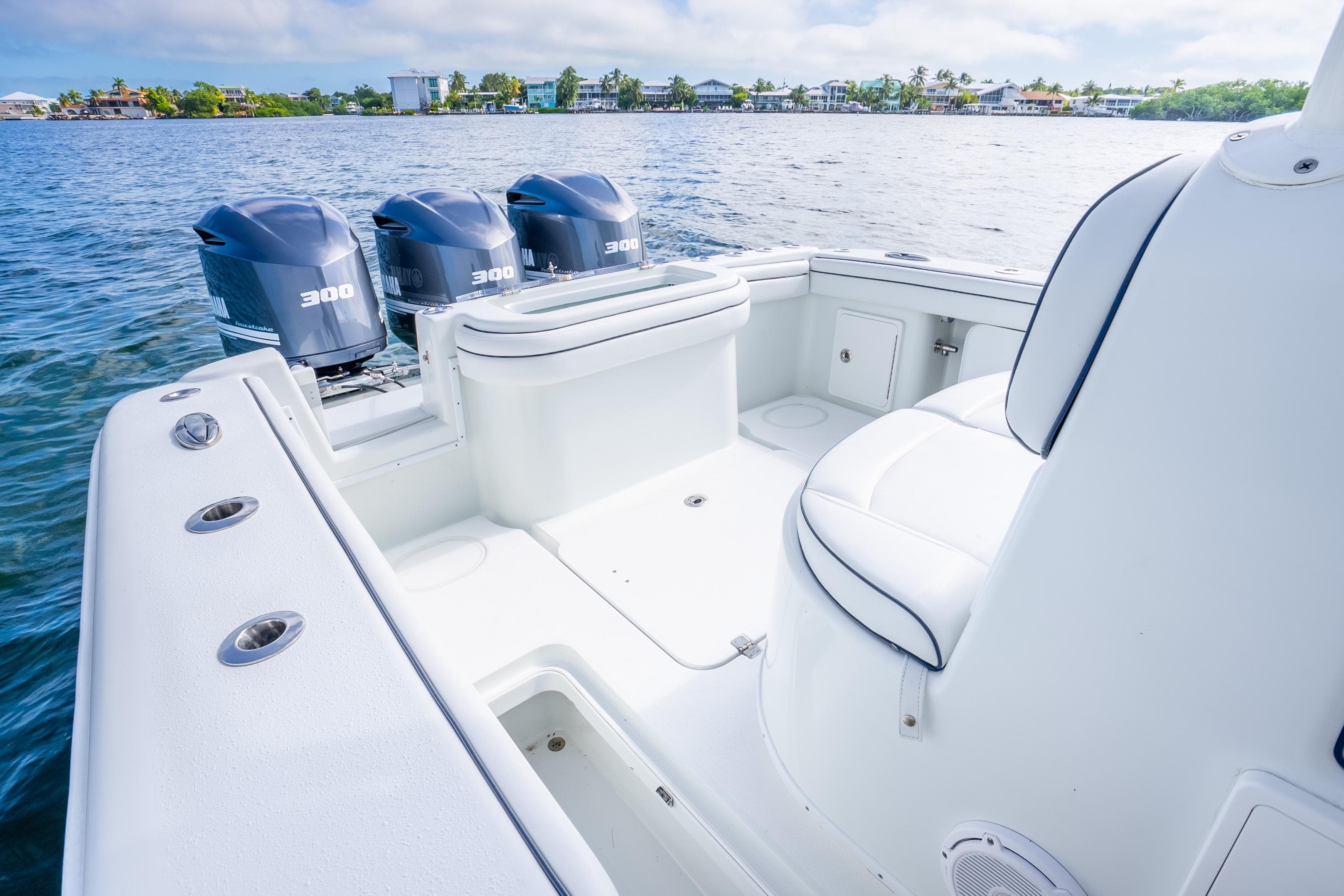 2016 Yellowfin 36 Offshore boat with triple 300 horsepower engines on calm water.