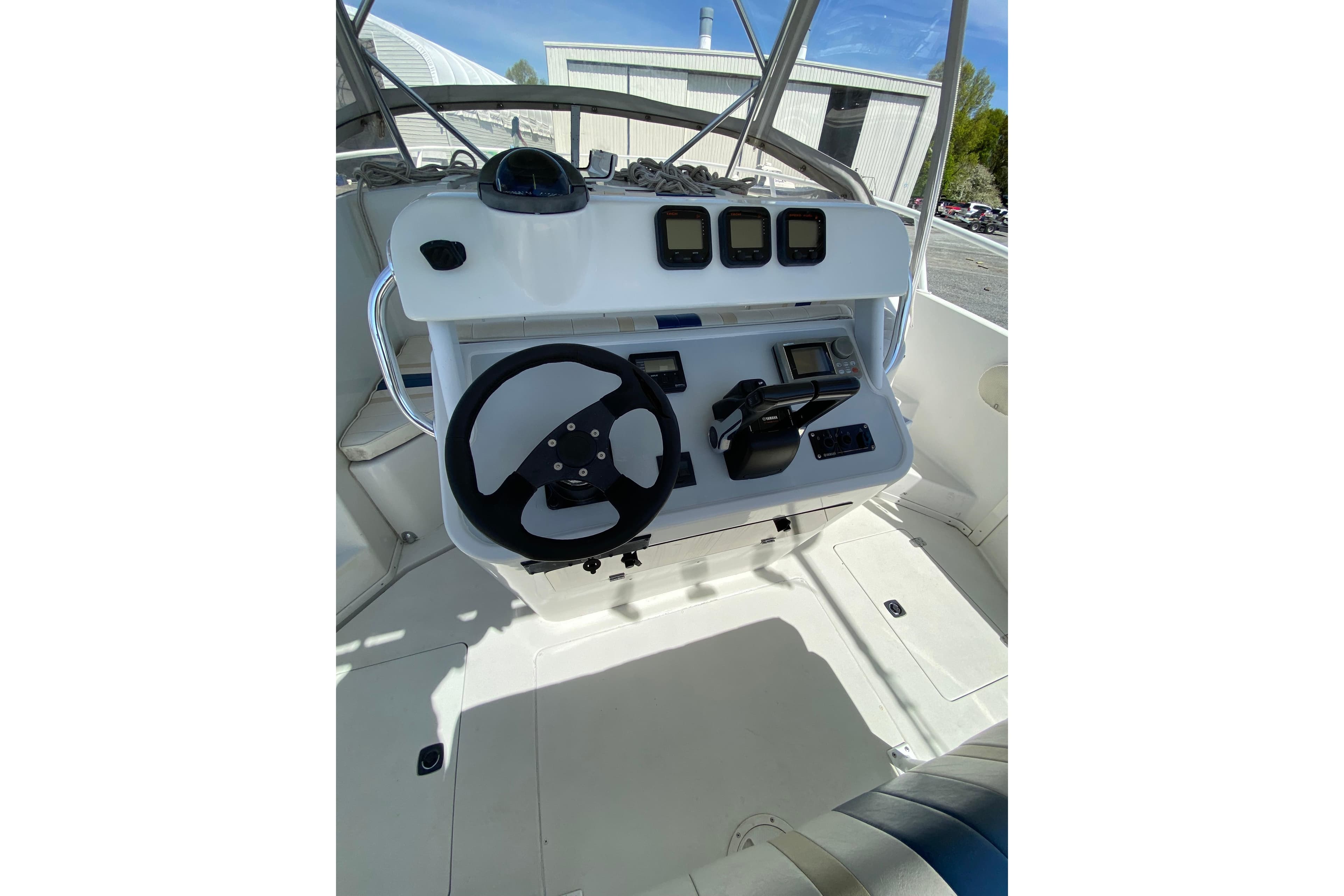 1996 Intrepid 337 boat helm with steering wheel and navigation controls.
