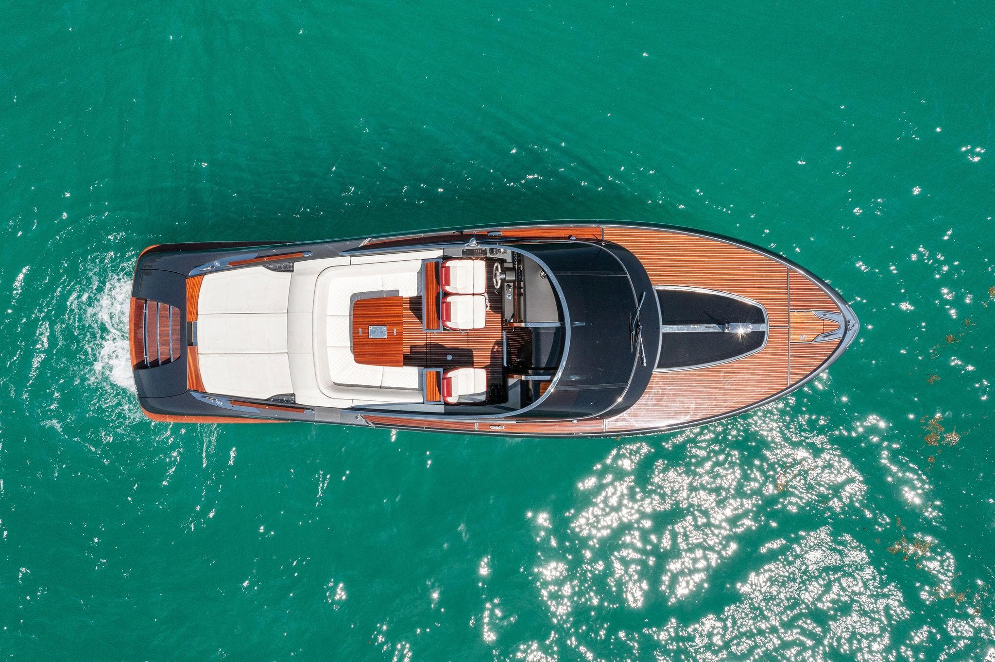 Aerial view of 2022 Riva 38 Rivamare yacht on turquoise water.