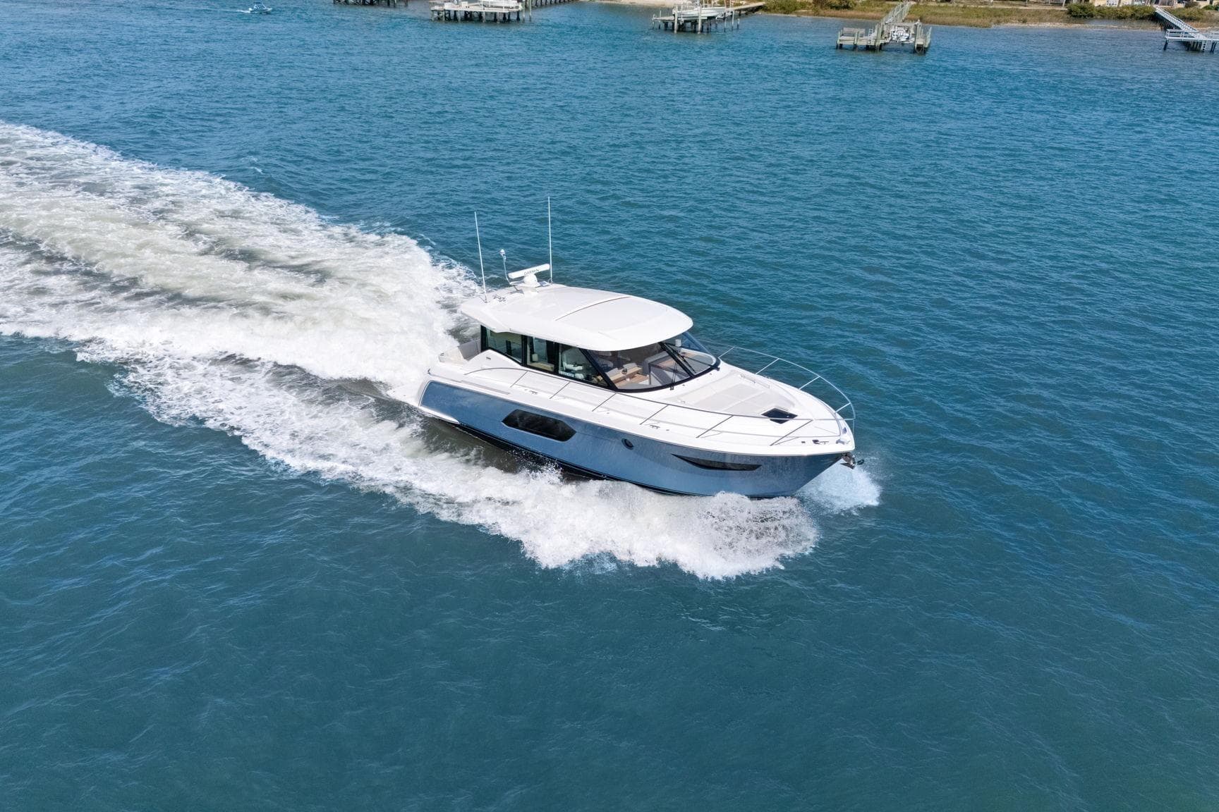 2023 Tiara Yachts C49 Coupe cruising on open water, showcasing sleek design and performance.