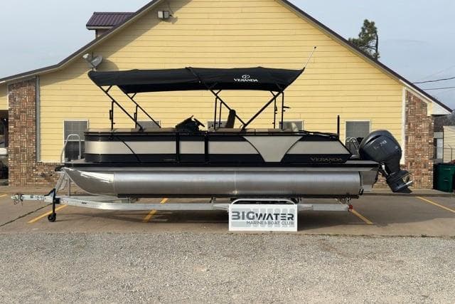 2026 Veranda VR235F2 pontoon boat parked in front of a yellow building.